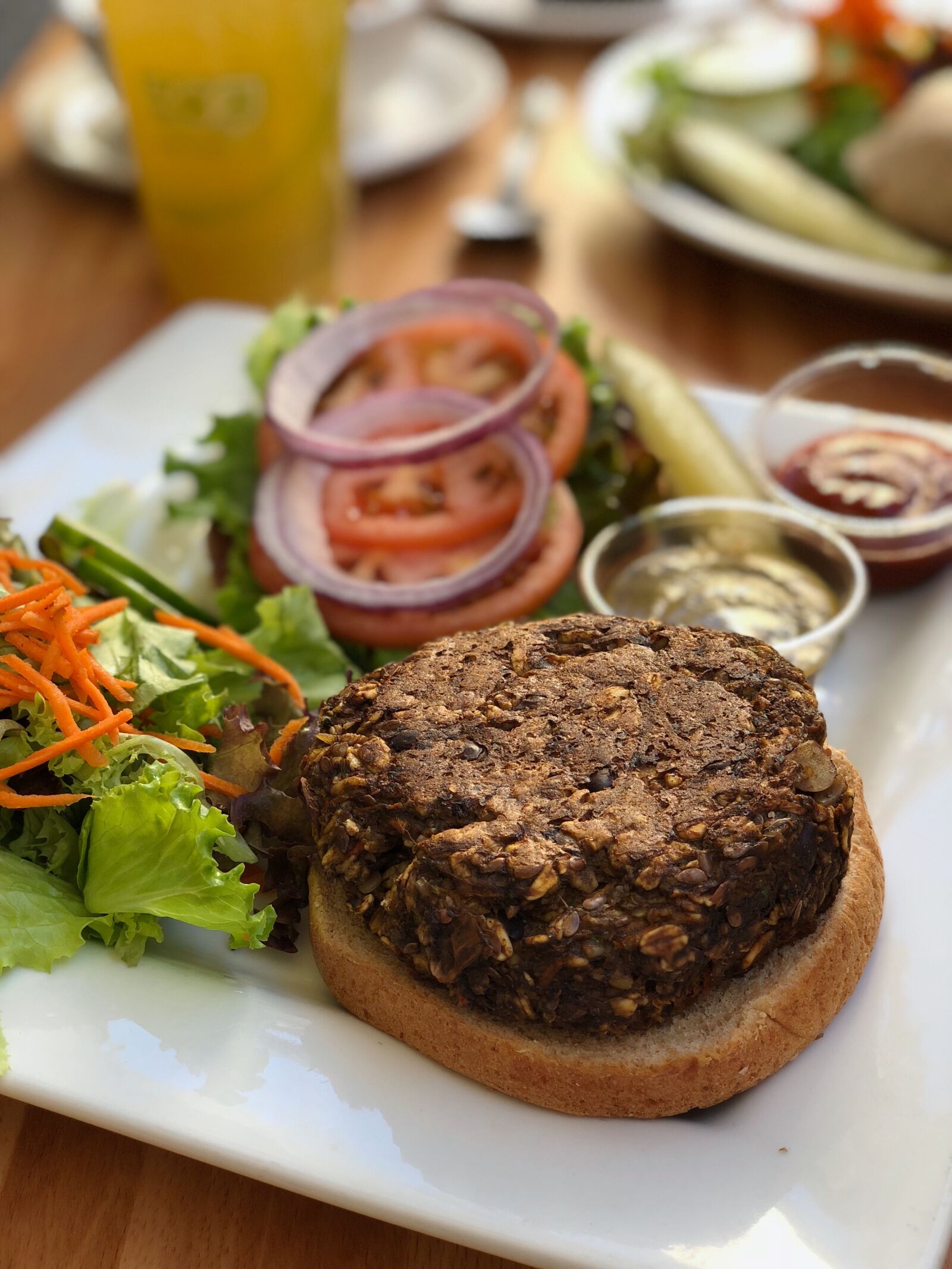 iPhone X back dual camera 6mm f/2.4 sample photo. Veggie burger, salad, healthy photography