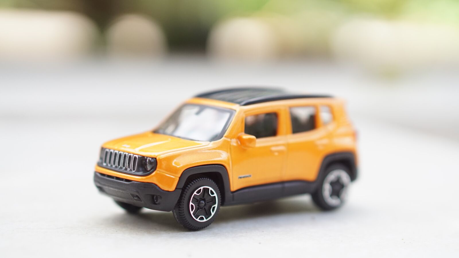 E 50mm F1.8 OSS sample photo. Toy, jeep, yellow photography