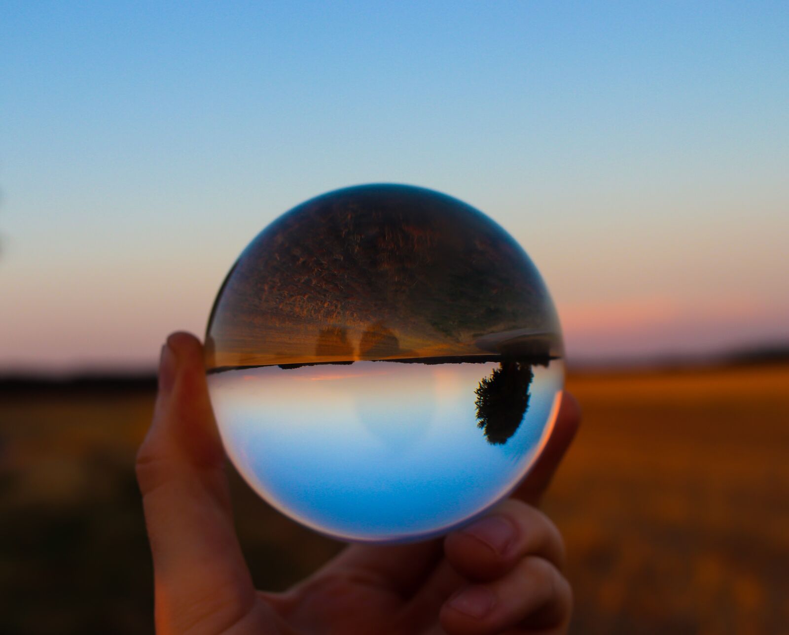 Canon EF-S 24mm F2.8 STM sample photo. Sphere, horizon, hand photography
