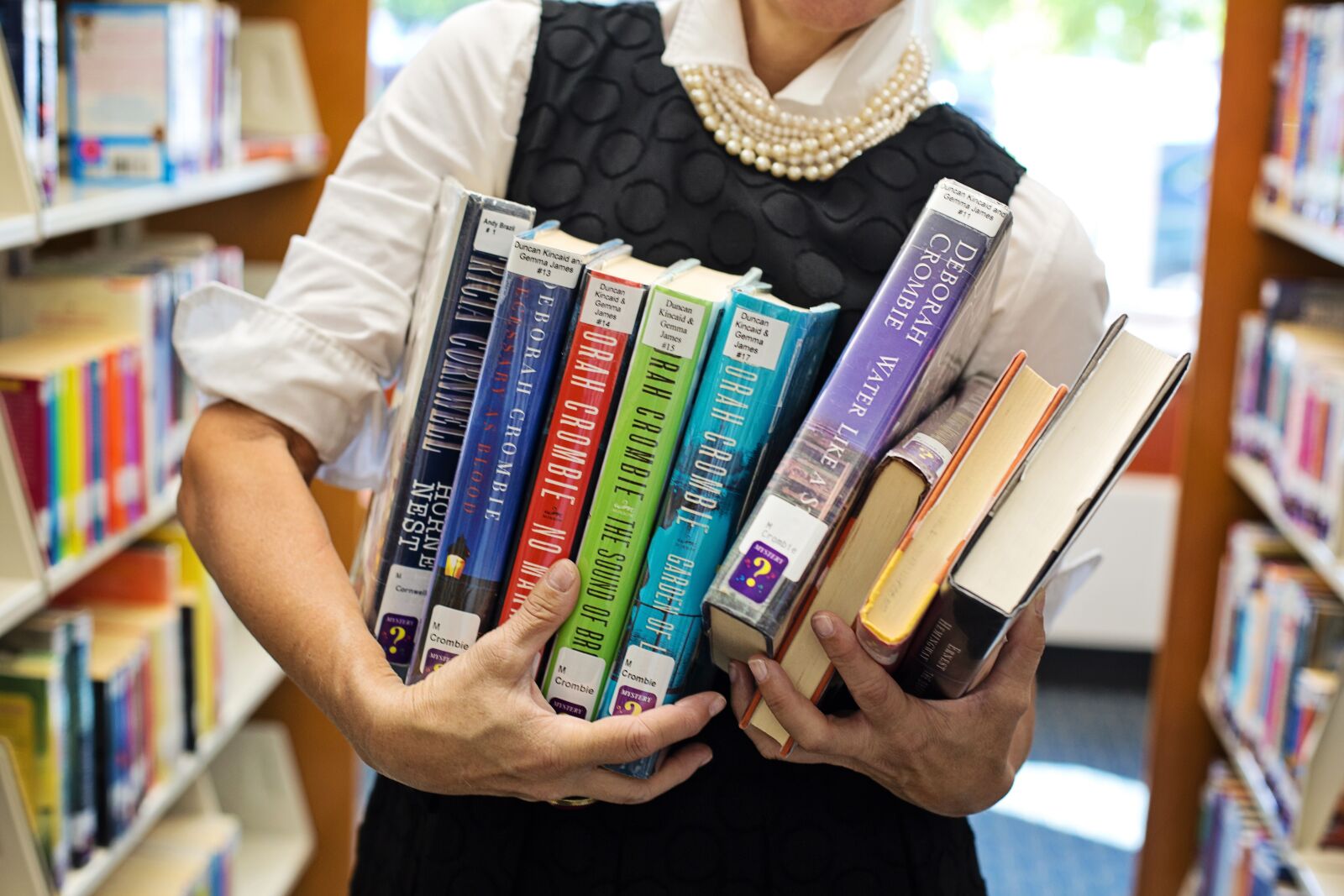Canon EF 50mm F1.4 USM sample photo. Library, books, woman holding photography