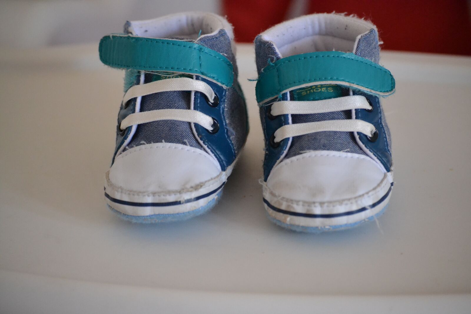Nikon D3100 sample photo. Baby shoes, childcare, toddler photography