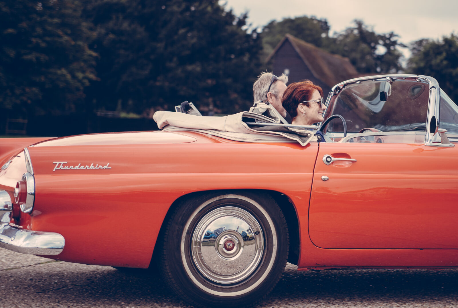 Canon EF 28-70mm f/2.8L USM sample photo. Couple, riding, red, ford photography