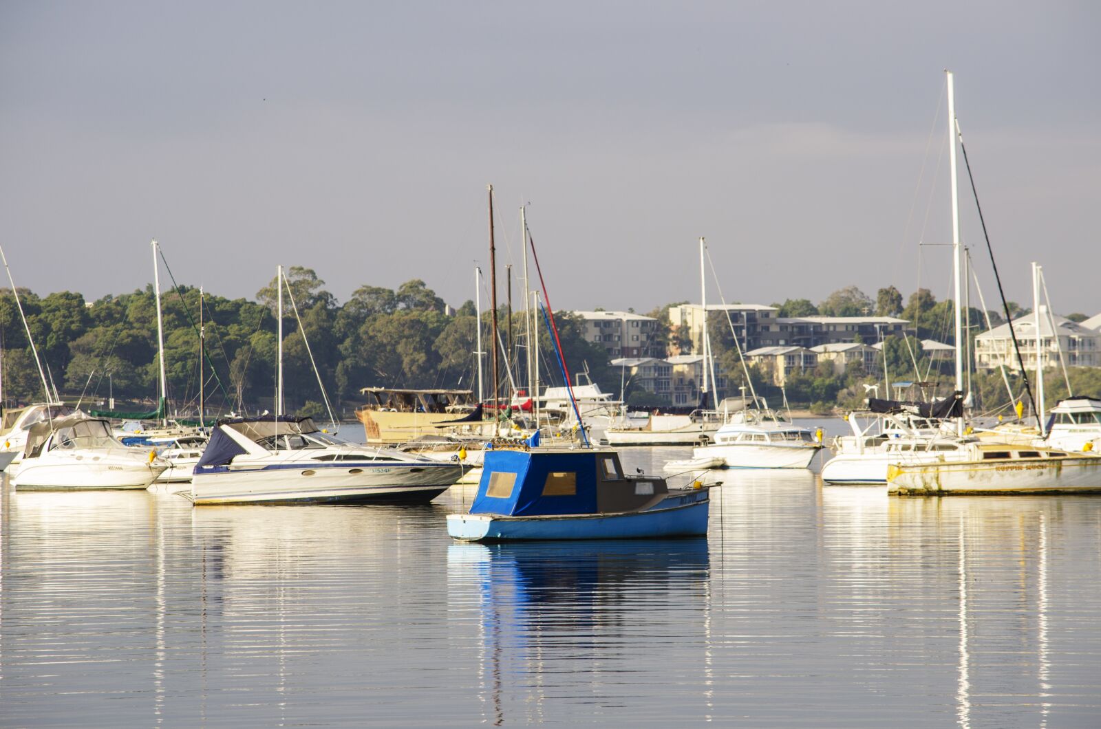 Nikon D5100 sample photo. Blue boat, bay, coast photography