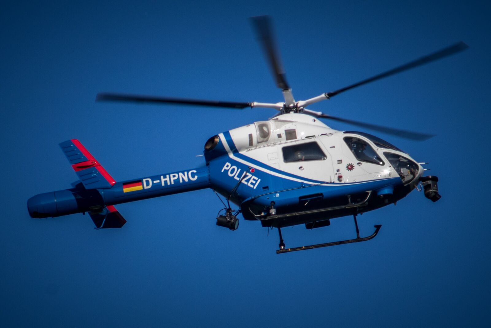 Canon EF 75-300mm F4.0-5.6 IS USM sample photo. Helicopter, blue, flying photography