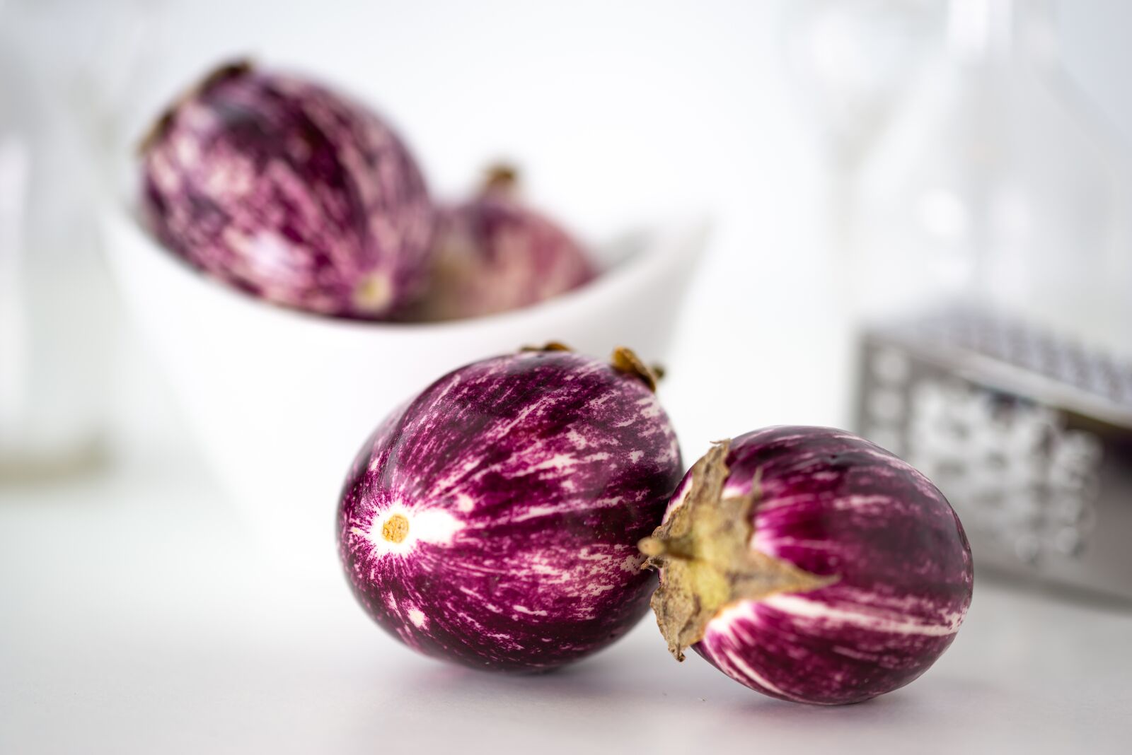 Nikon D610 sample photo. Eggplant, kitchen grater, white photography