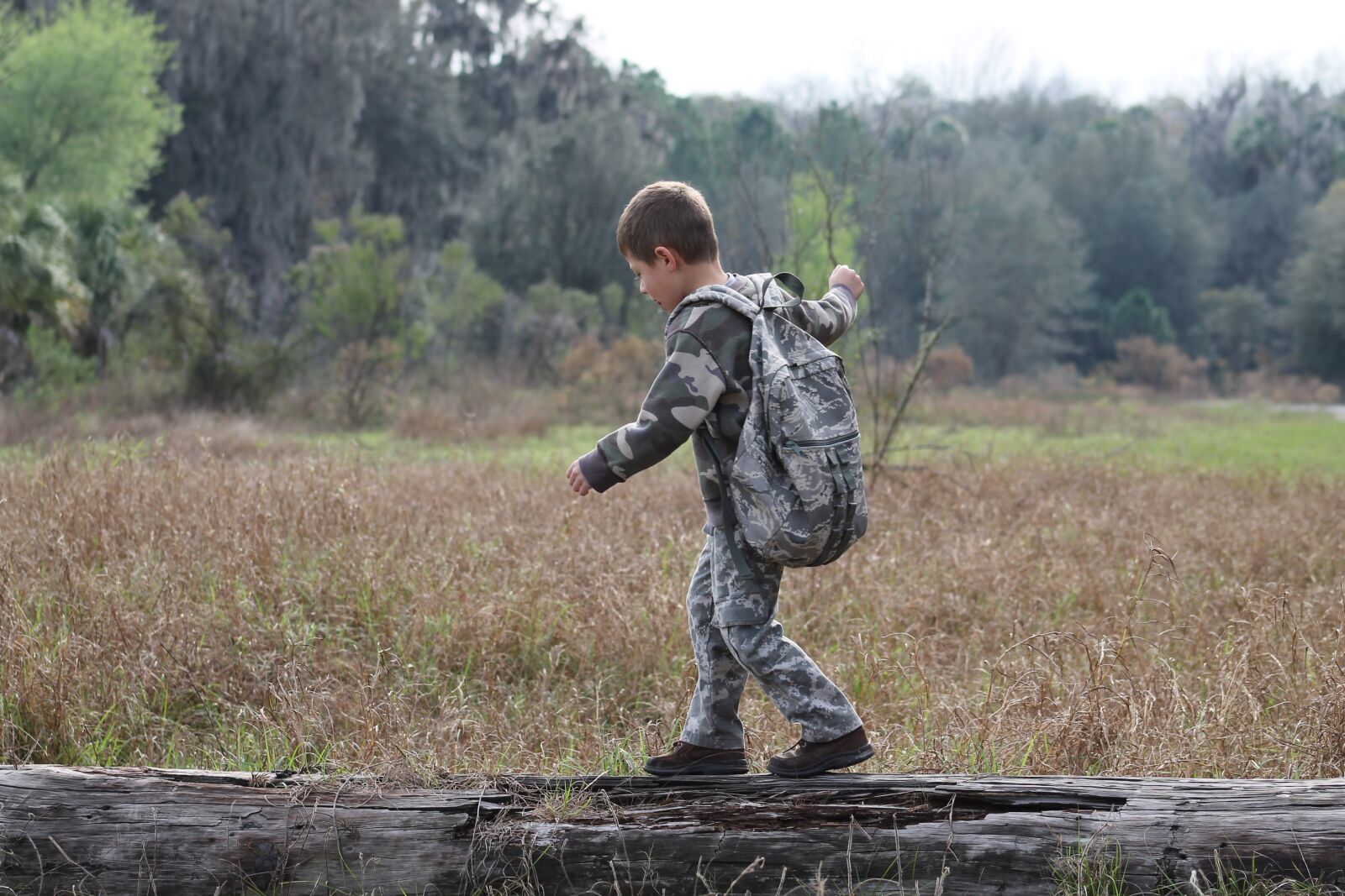 Canon EF 75-300mm f/4-5.6 sample photo. Boy, camouflage, outdoors photography