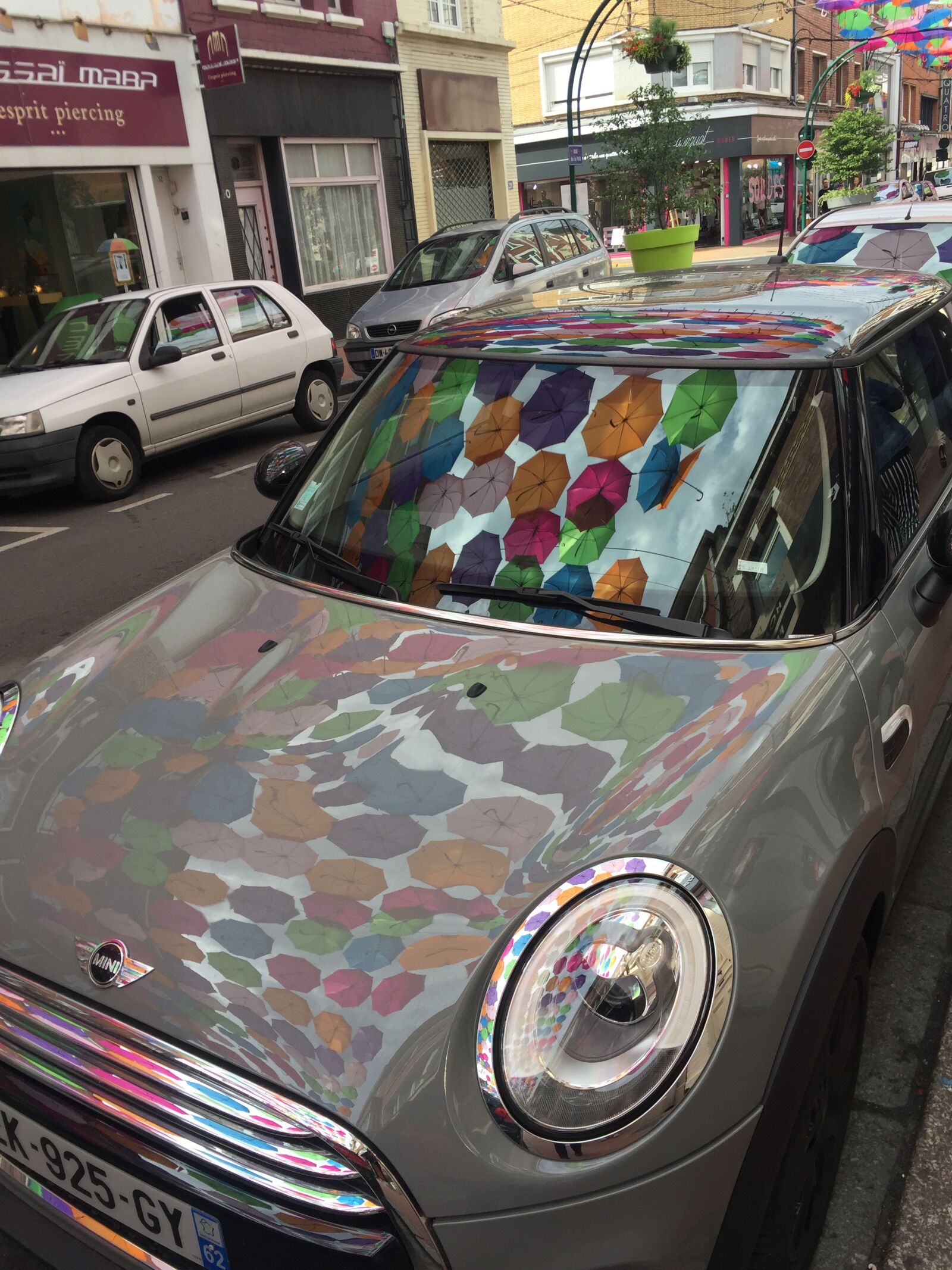 iPhone 6 back camera 4.15mm f/2.2 sample photo. Umbrellas, reflections, mini photography