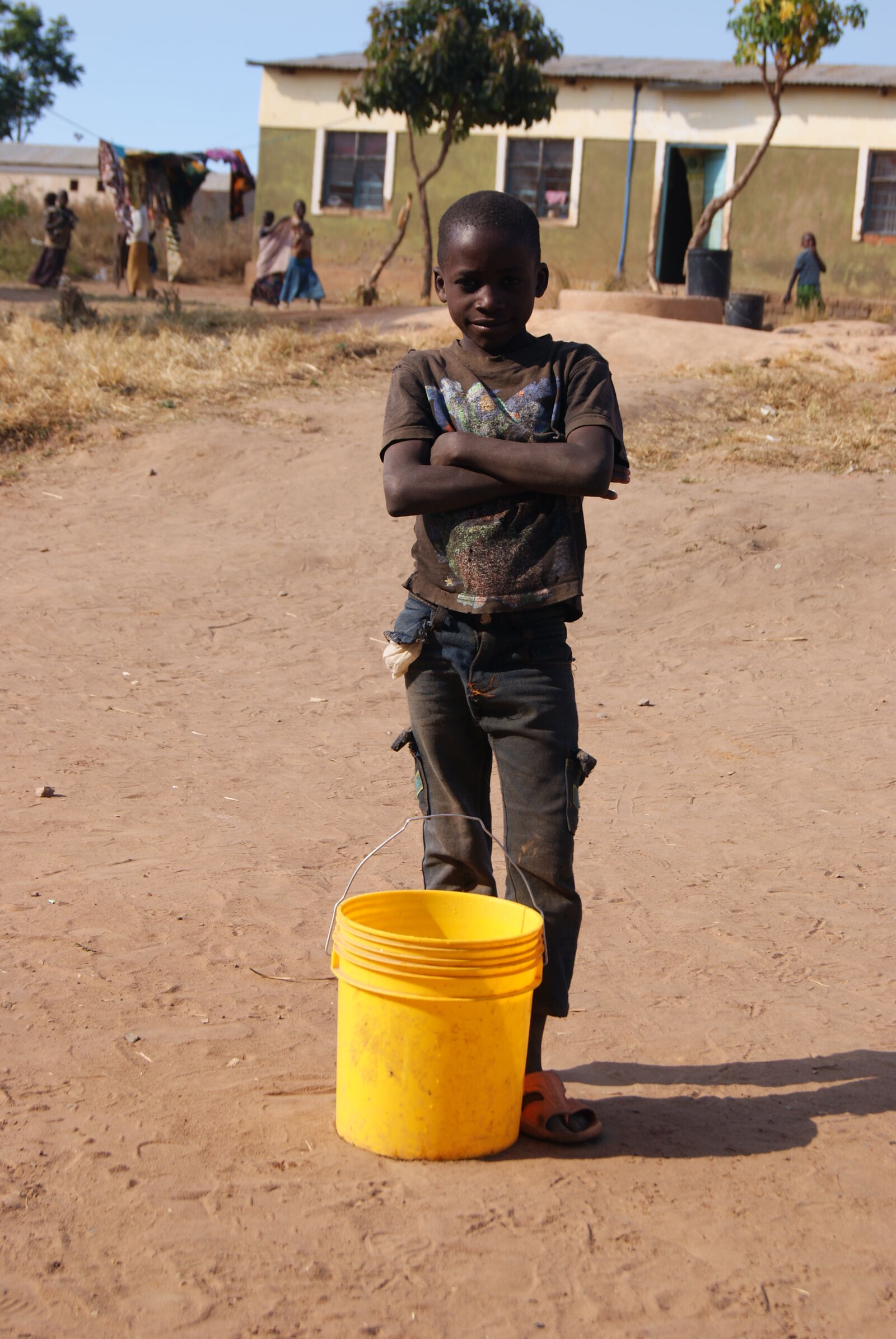 Sony Alpha DSLR-A230 sample photo. Africa, boy, bucket, sand photography