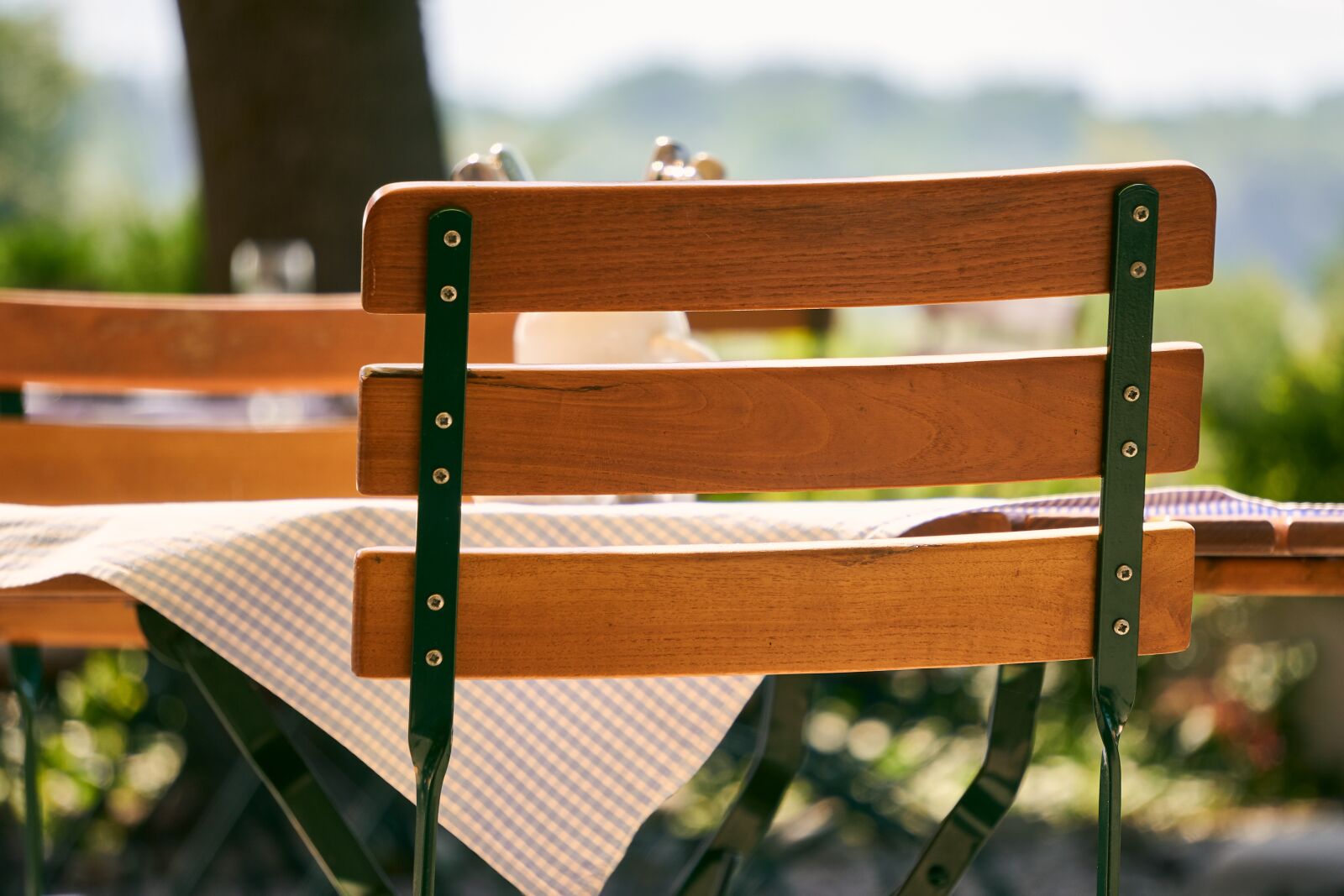 Sony E 55-210mm F4.5-6.3 OSS sample photo. Beer garden, chair, bistro photography