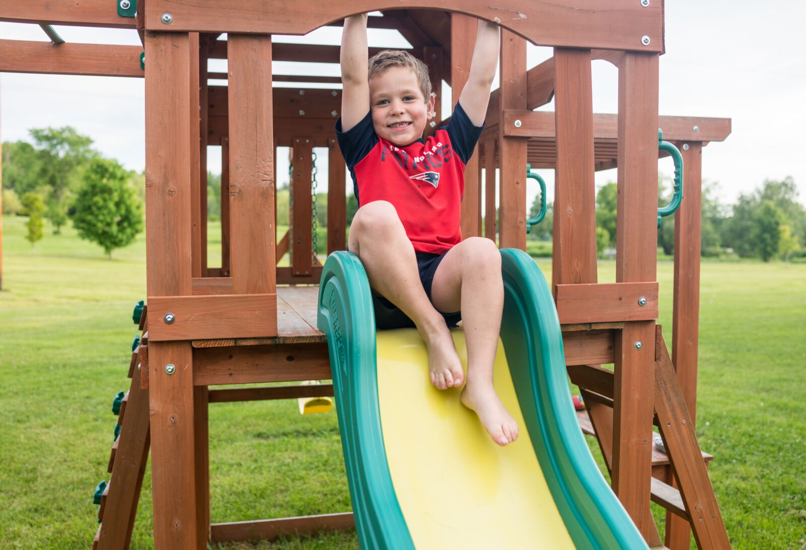 35mm F2.0 sample photo. Playground child, boy, slide photography