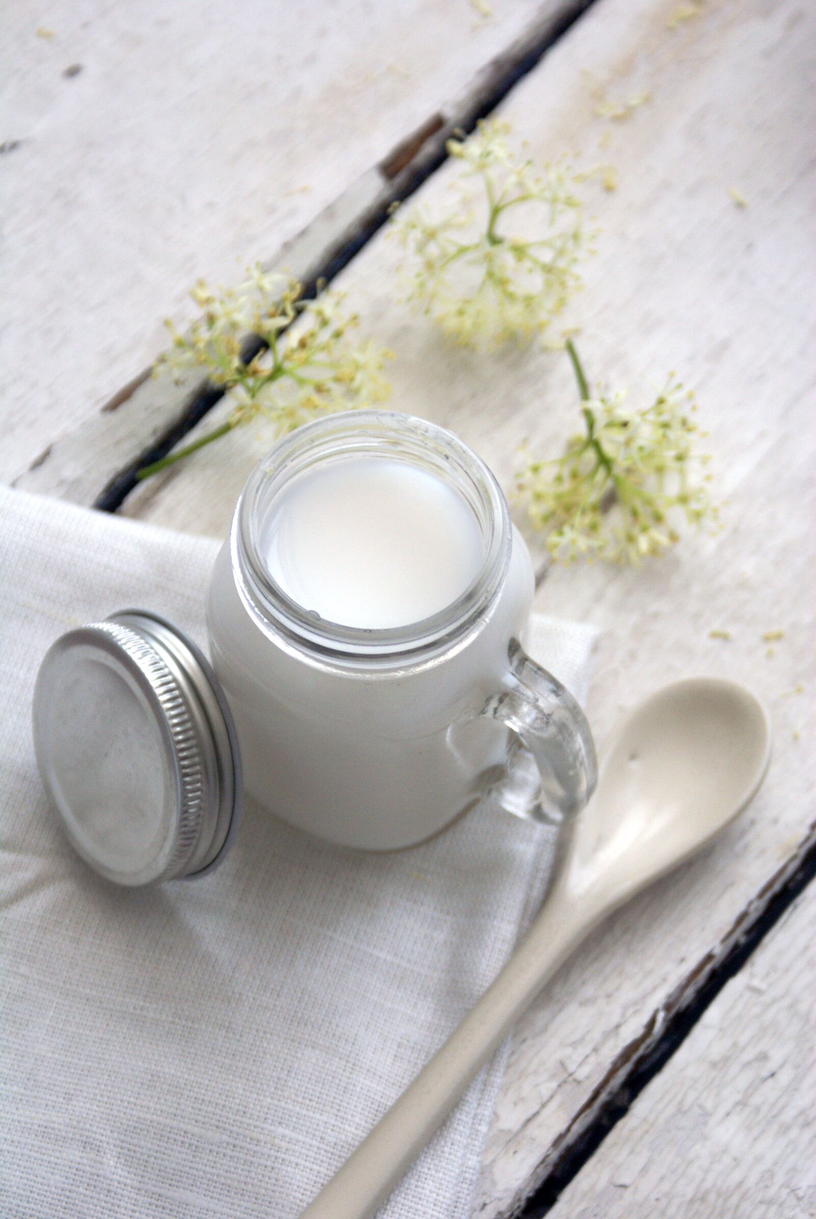 Sony Alpha DSLR-A100 sample photo. Milk, white flower, spoon photography
