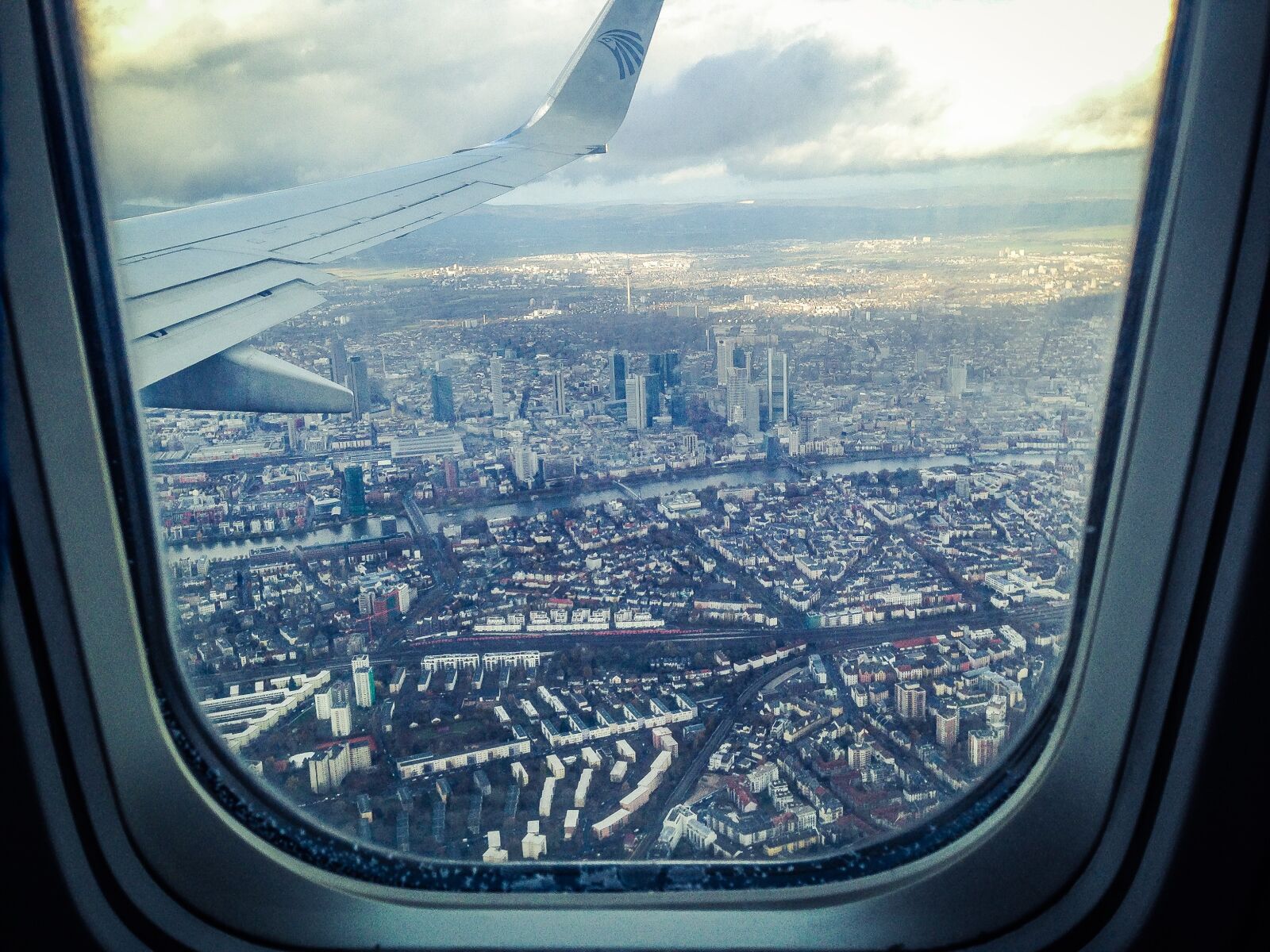 iPhone 5c back camera 4.12mm f/2.4 sample photo. Airplane, windowpane, showing, city photography