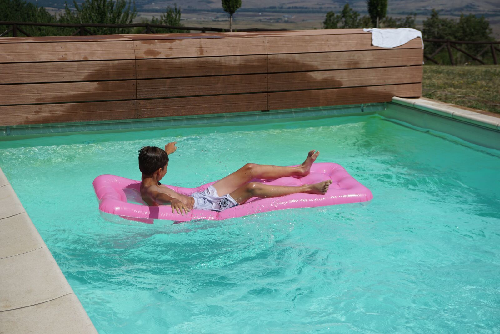 Sony E 16-50mm F3.5-5.6 PZ OSS sample photo. Summer, boy, pool photography