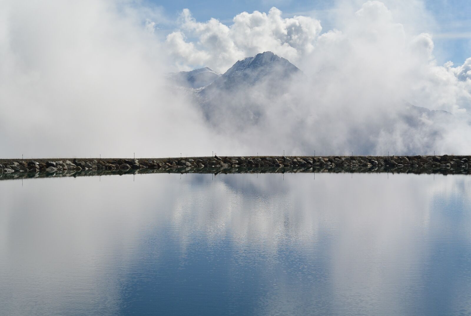 Nikon 1 S1 sample photo. Scuol, lake, clouds photography
