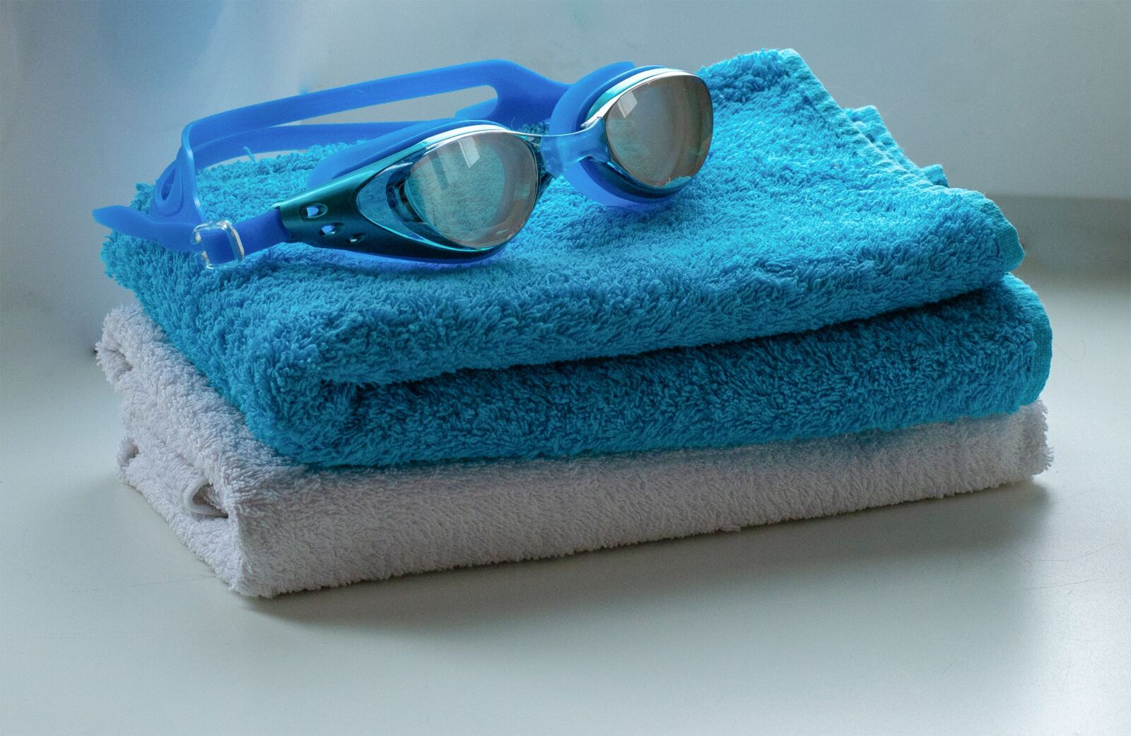 Nikon D3100 sample photo. Towel, goggles, pool photography