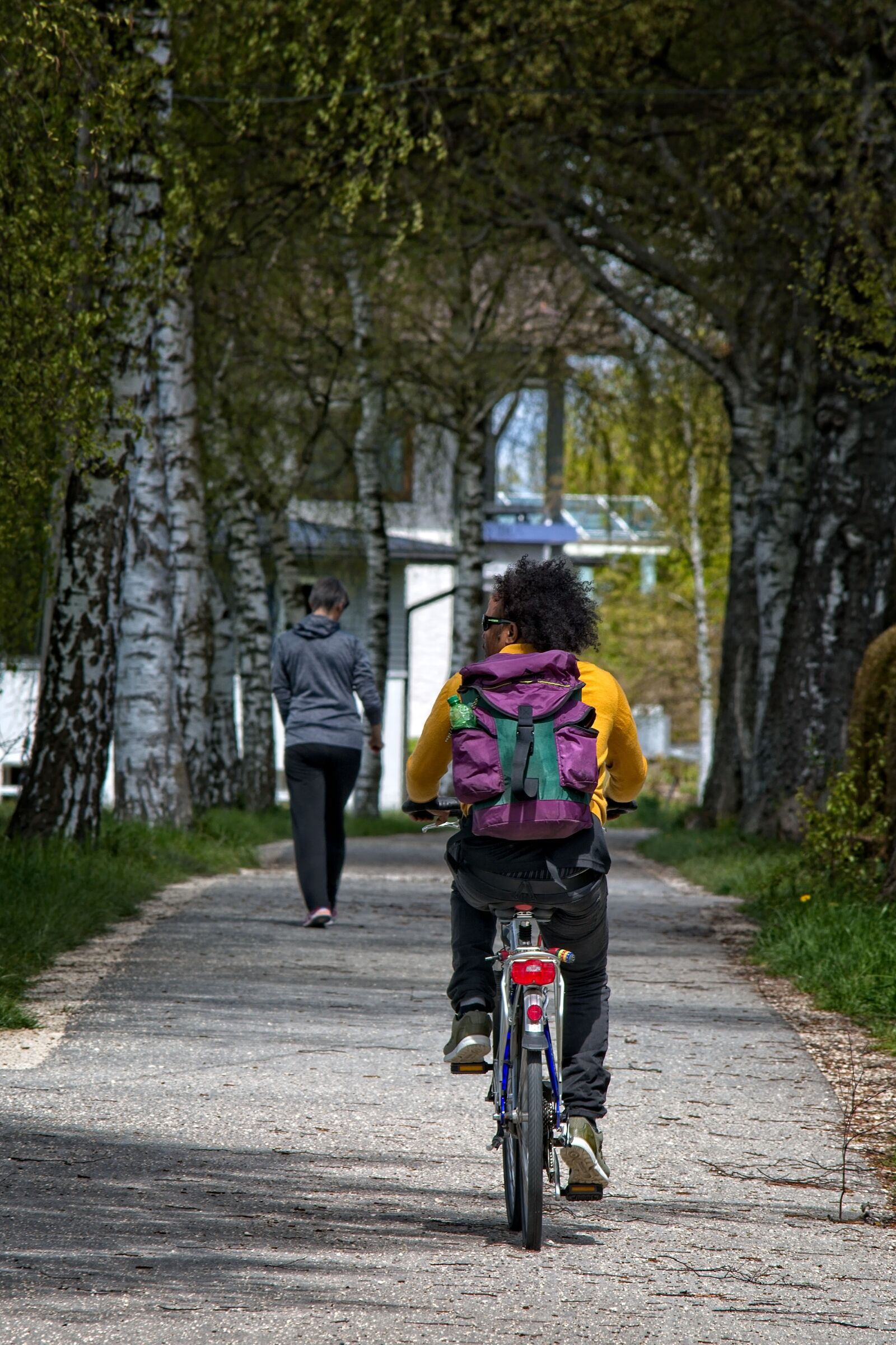 55.0-200.0mm f/4.0-f/5.6 sample photo. Cyclists, away, cycle path photography