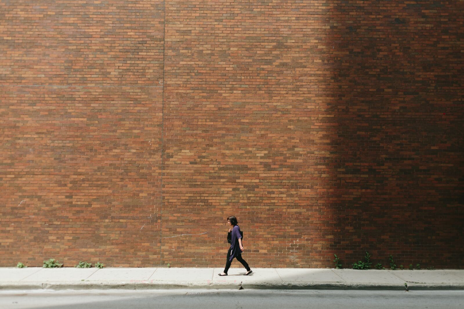 Canon EF 50mm F1.8 II sample photo. Brick wall, girl, pavement photography