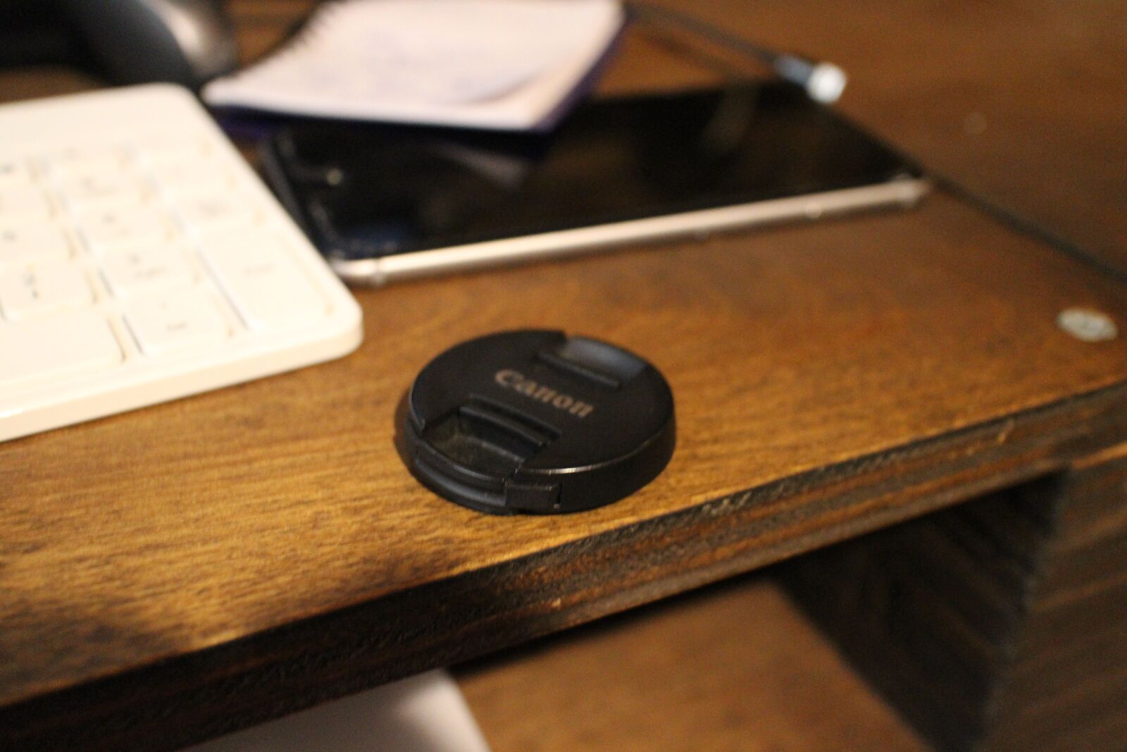 Canon EOS M sample photo. Caps, iphone, desk photography