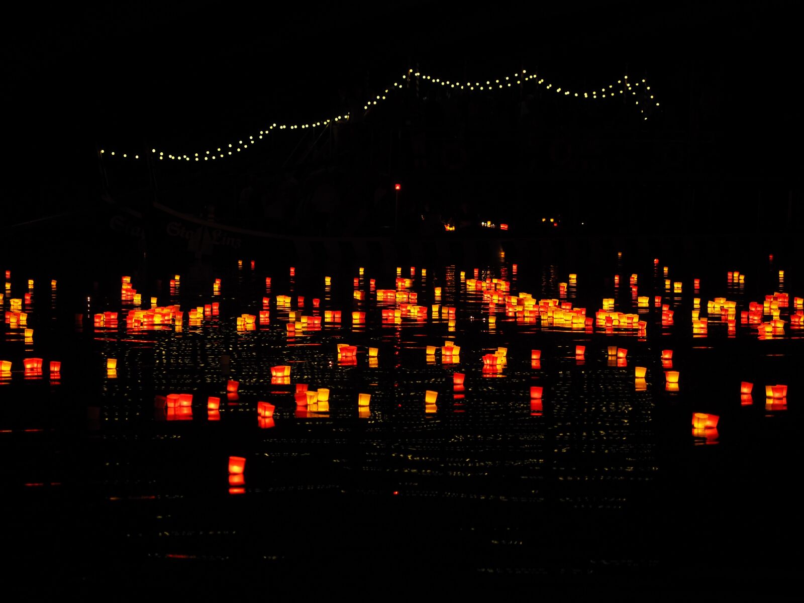 Olympus OM-D E-M1 + Olympus M.Zuiko Digital ED 12-40mm F2.8 Pro sample photo. Candles, lights serenade, river photography