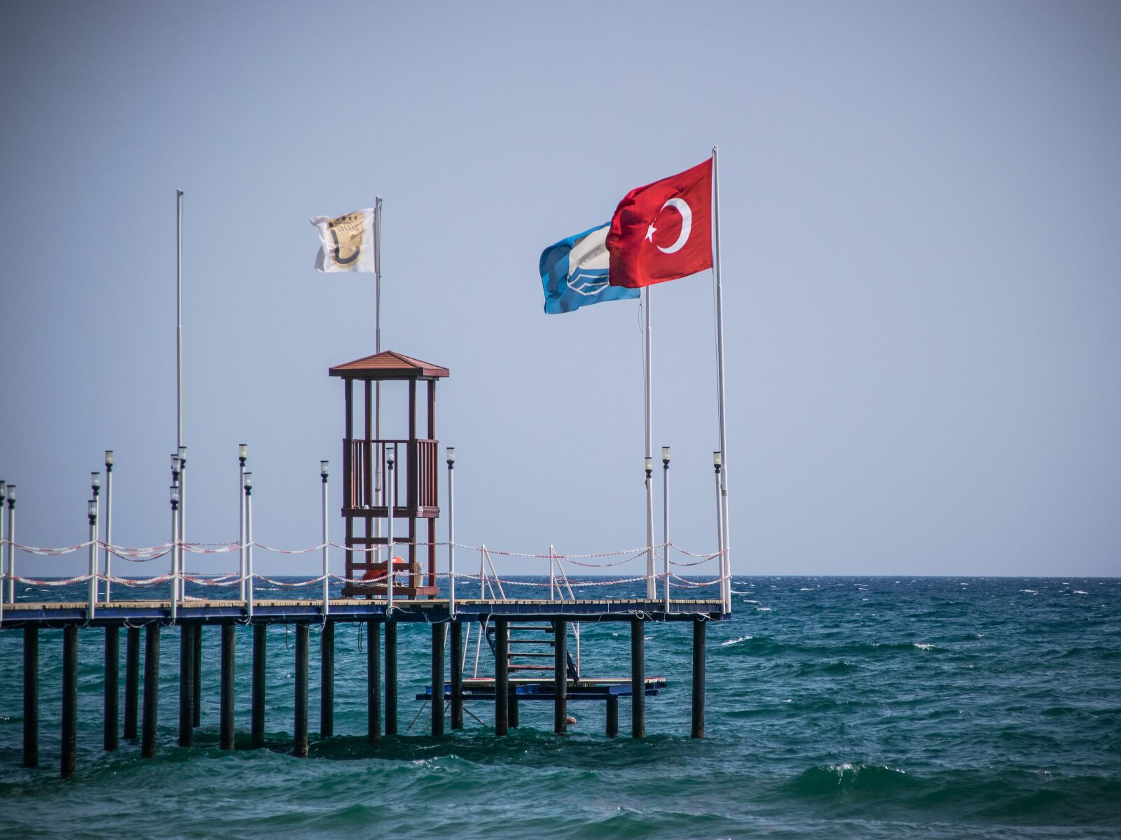 Nikon D5300 sample photo. Pier, flag, sea photography