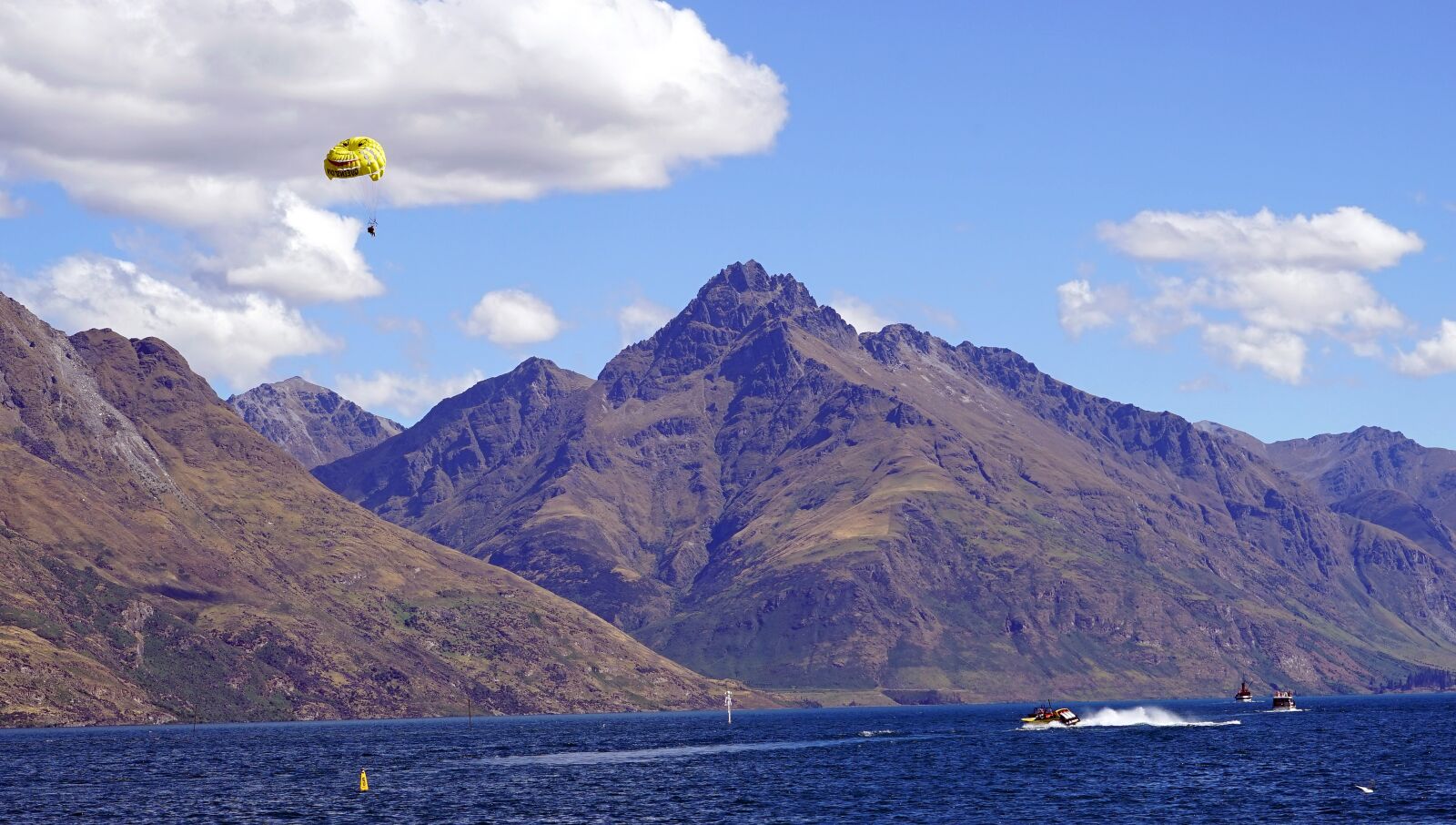 Sony a7 + Sony FE 24-240mm F3.5-6.3 OSS sample photo. Parasailing, lake, mountains photography