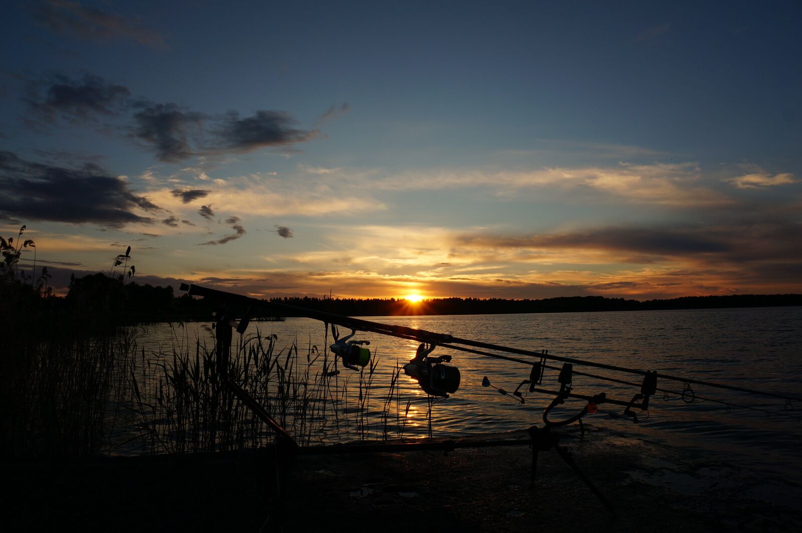 Sony Alpha NEX-5T + Sony E 16-50mm F3.5-5.6 PZ OSS sample photo. Sunset, fishing, twilight photography