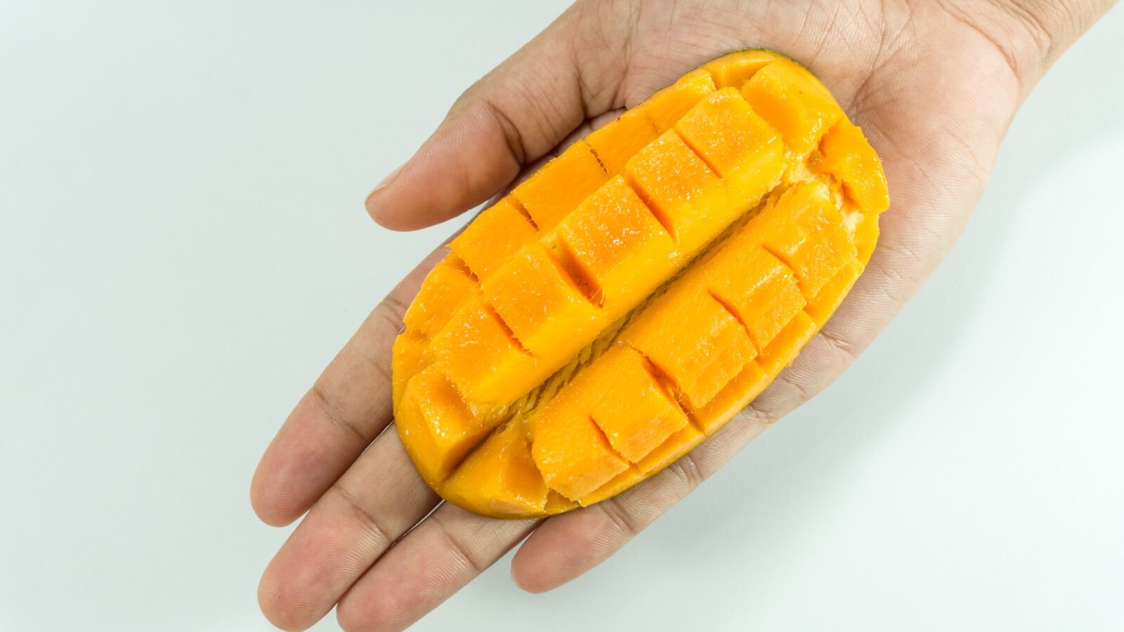Sony a5100 sample photo. Mango, slice, on hand photography