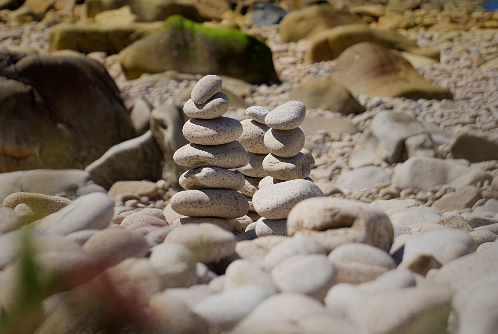 Sony E 55-210mm F4.5-6.3 OSS sample photo. Beach, pebbles, stones photography