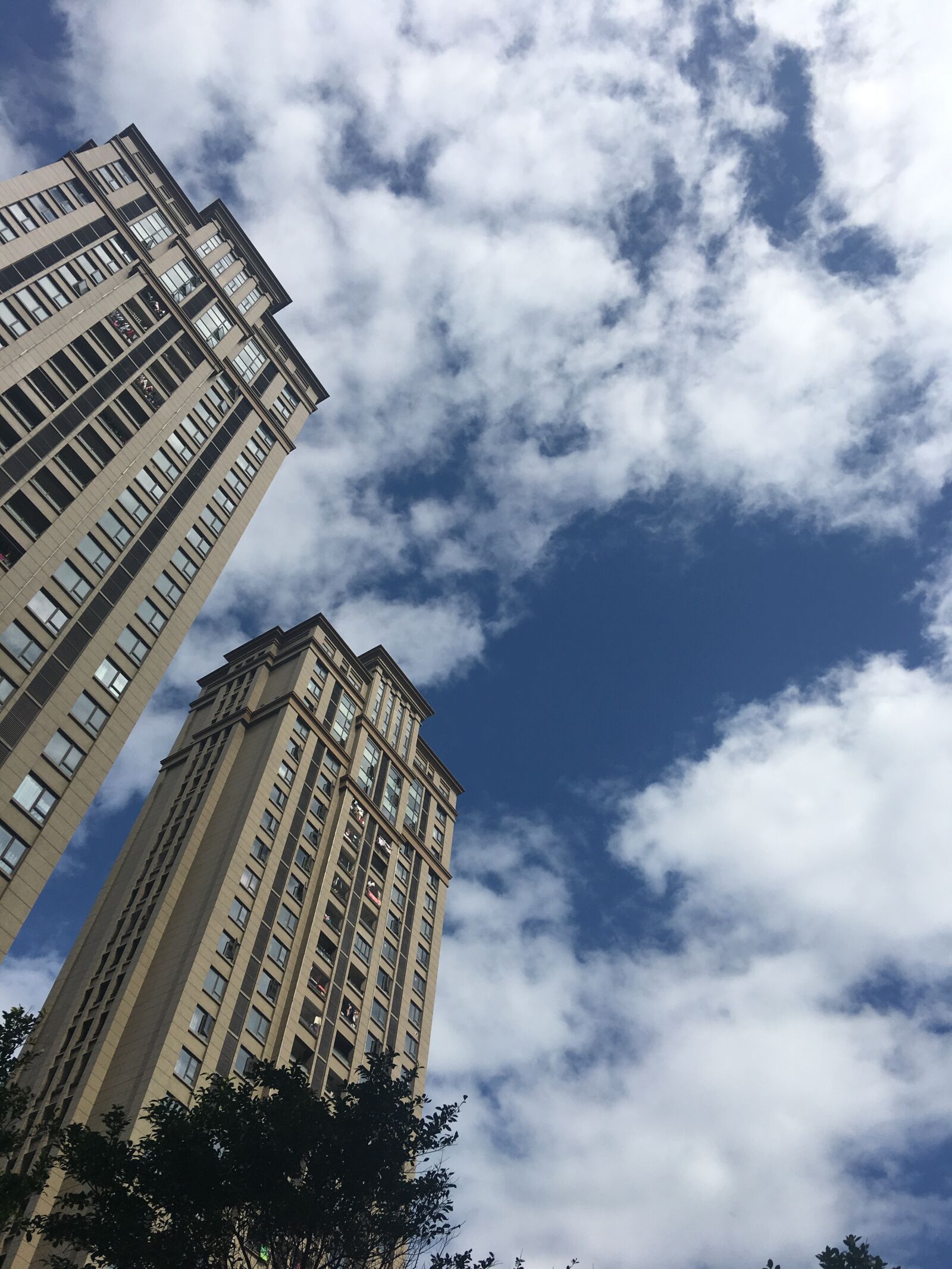 Apple iPhone 6s Plus sample photo. Tall buildings, look, blue photography