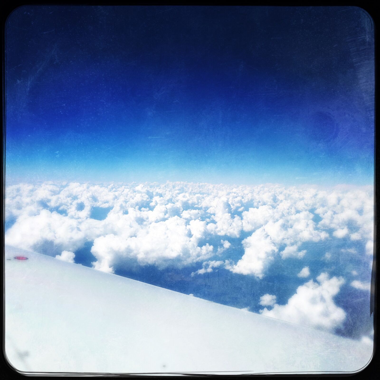Hipstamatic 339 + iPhone 6s back camera 4.15mm f/2.2 sample photo. Blue, clouds, flight photography