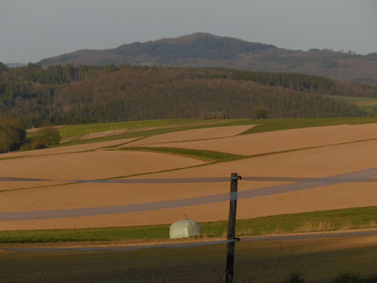 Panasonic Lumix DMC-FZ200 sample photo. Hay bales, mountains, nature photography
