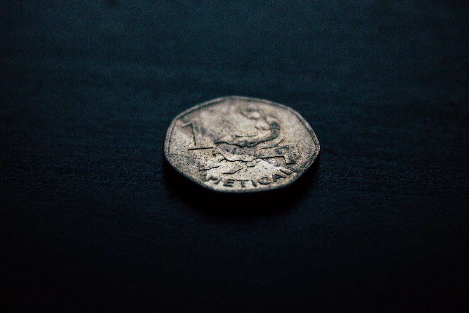 Canon EF-S 18-55mm F3.5-5.6 IS sample photo. Coin, table, dark photography