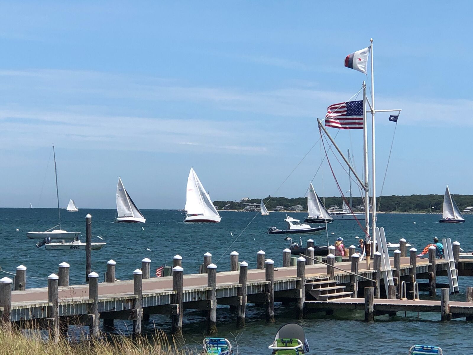 Apple iPhone 8 Plus + iPhone 8 Plus back dual camera 6.6mm f/2.8 sample photo. Sailboat, dock, flags photography