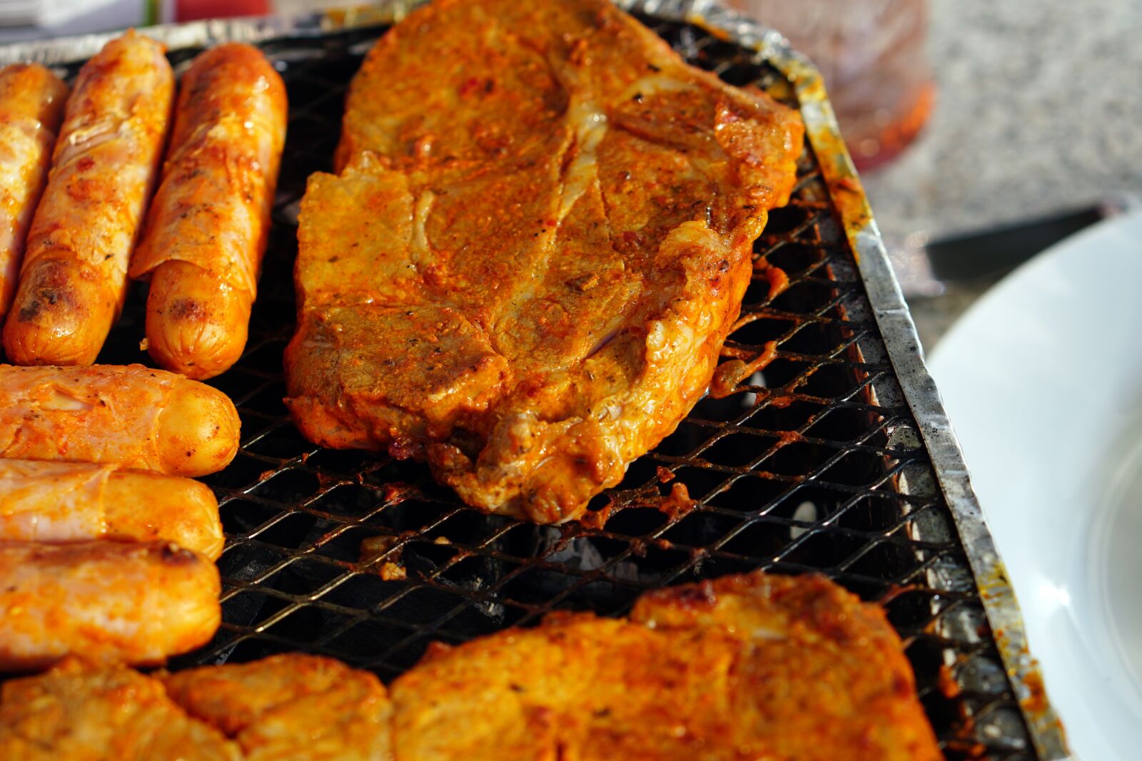 E 50mm F1.8 OSS sample photo. Meat, barbecue, eat photography