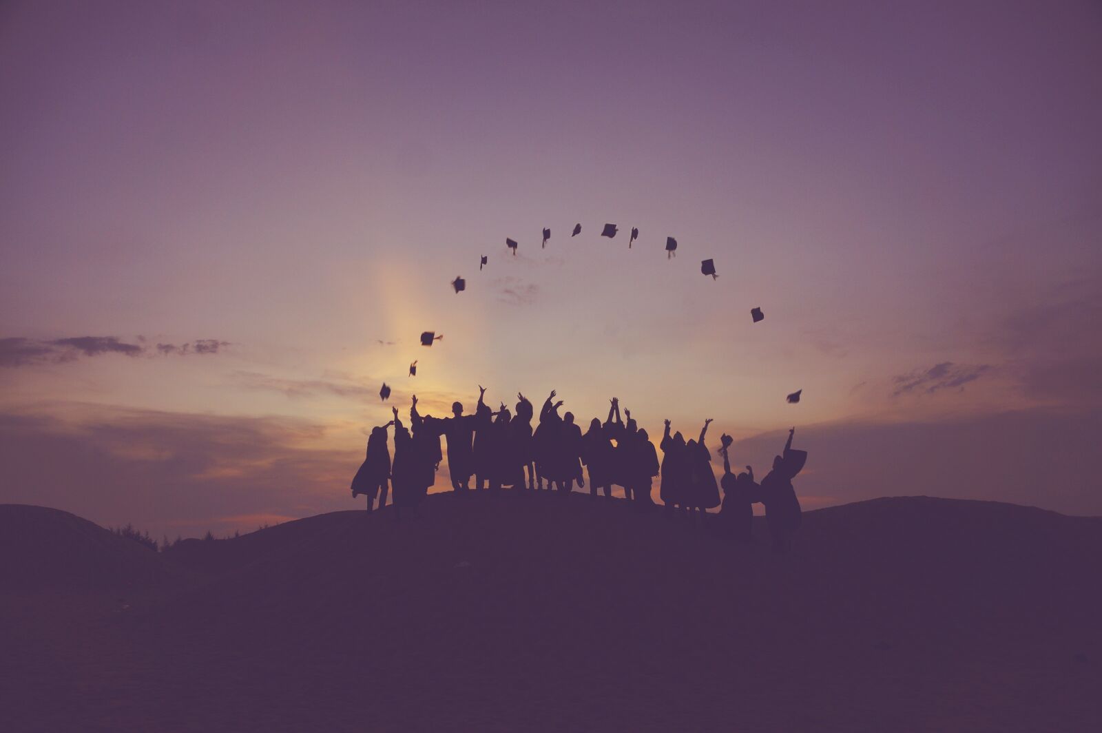 Sony DT 18-250mm F3.5-6.3 sample photo. Dawn, graduates, throwing hats photography
