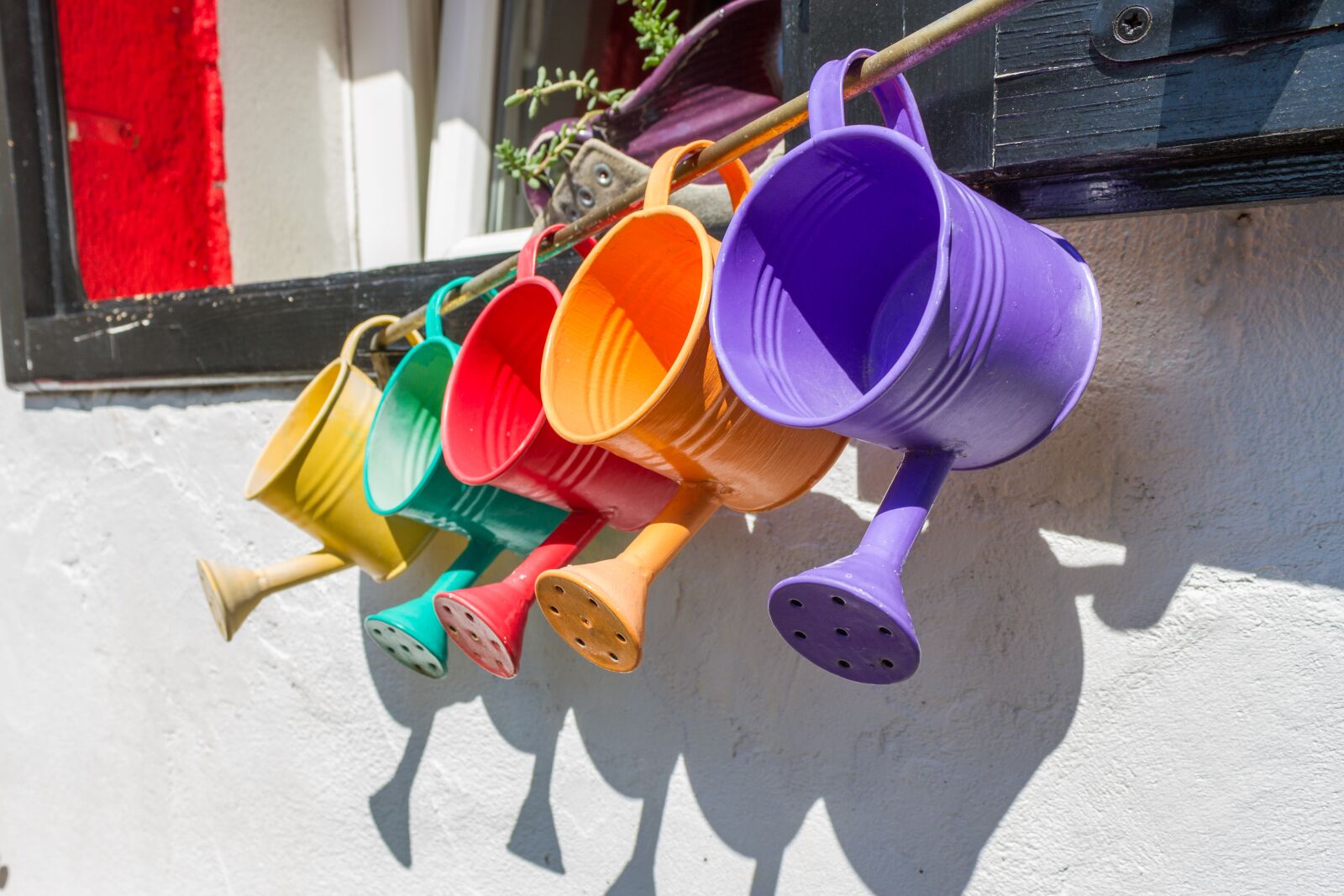 Canon EOS 7D + Canon EF-S 18-55mm F3.5-5.6 IS II sample photo. Colorful, watering cans, watering photography