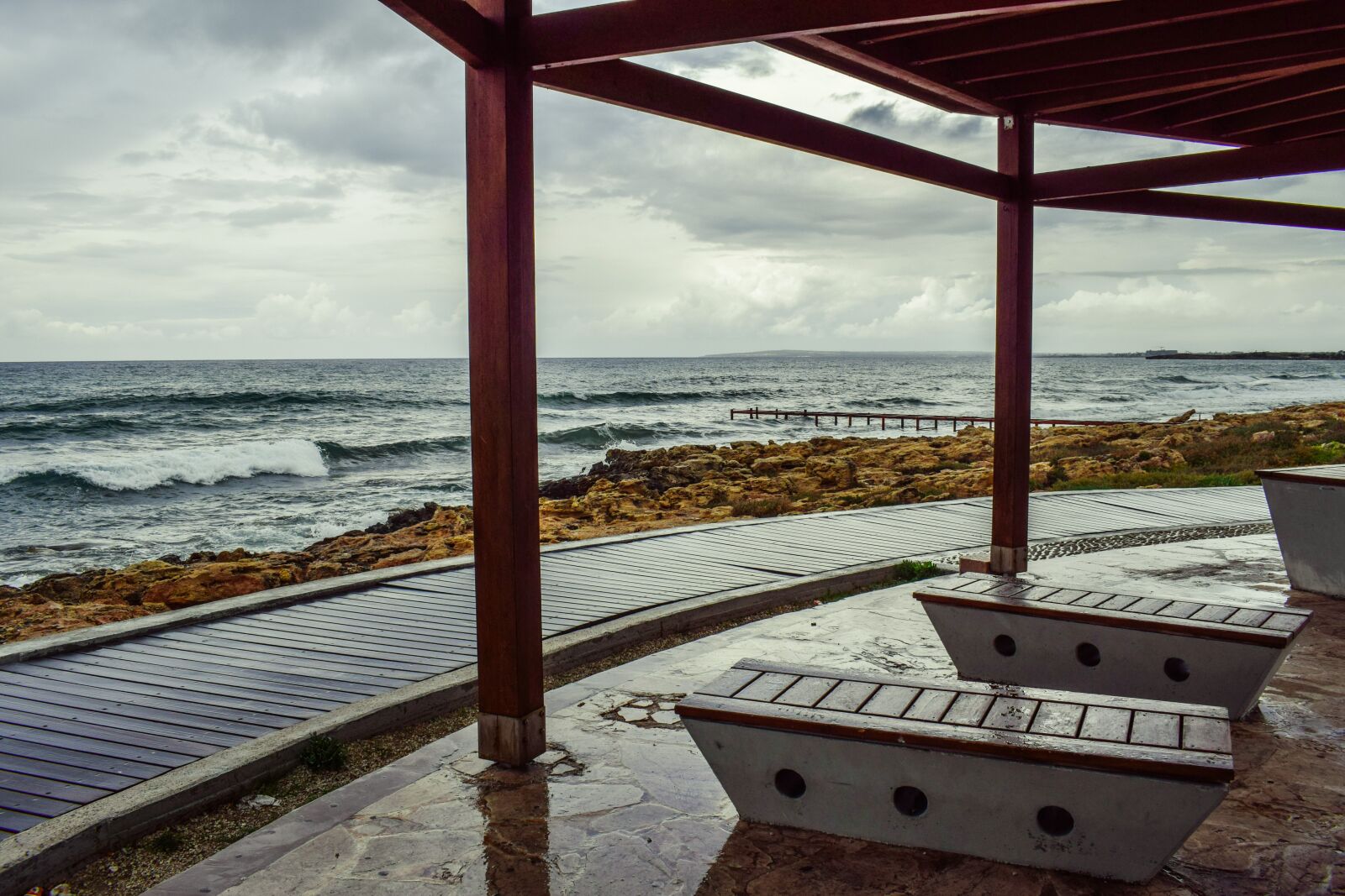 Nikon D3300 sample photo. Rainy day, kiosk, bench photography