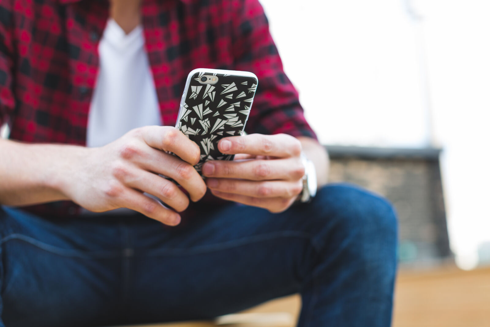 Canon EF 50mm F1.2L USM sample photo. Sitting, person, using, iphone photography