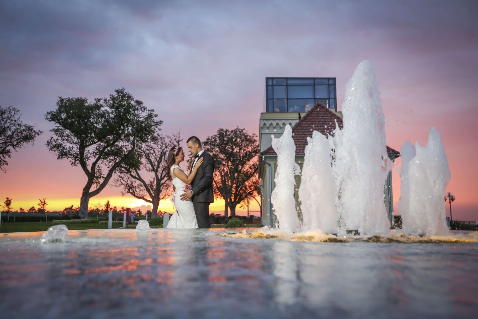 Canon EF 16-35mm F2.8L II USM sample photo. Bride, groom, sunset, fountain photography