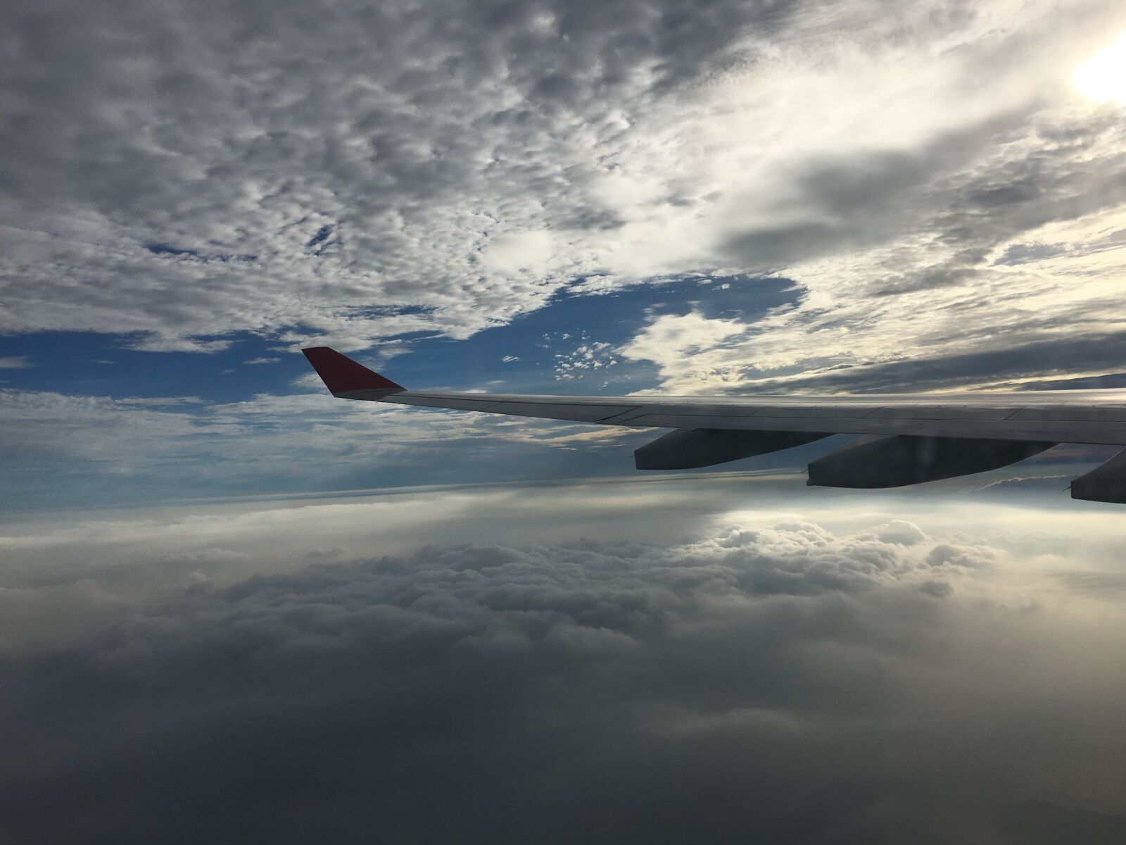 Apple iPhone 6s Plus sample photo. Clouds, sunlight, wing photography
