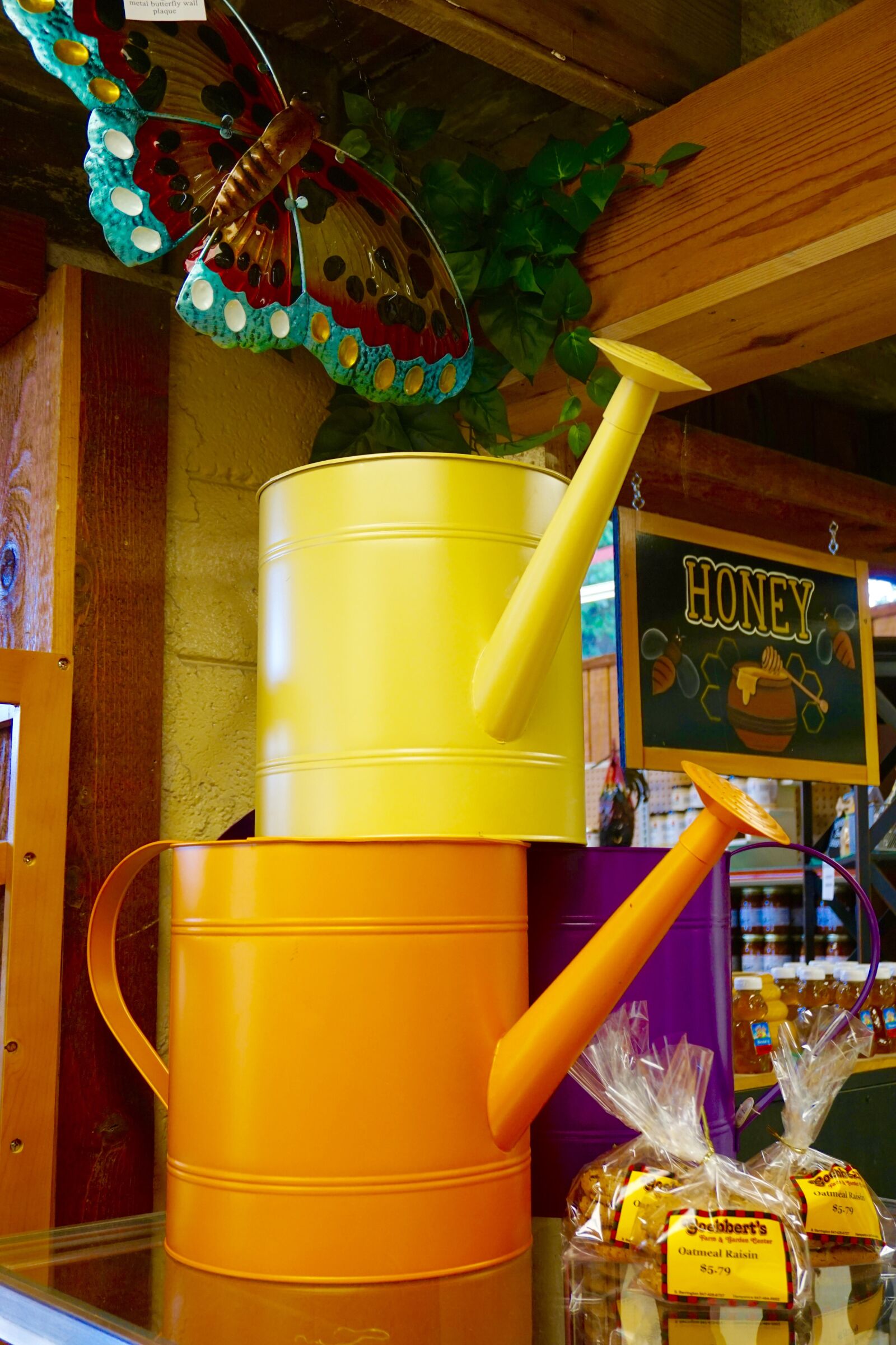 Sony a5100 sample photo. Farm shop, water cans photography