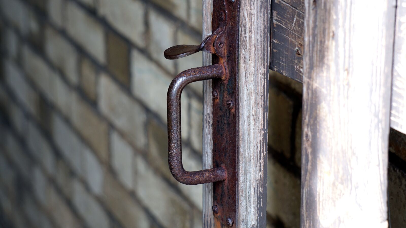 Sony E 55-210mm F4.5-6.3 OSS sample photo. Brick, brick wall, gate photography