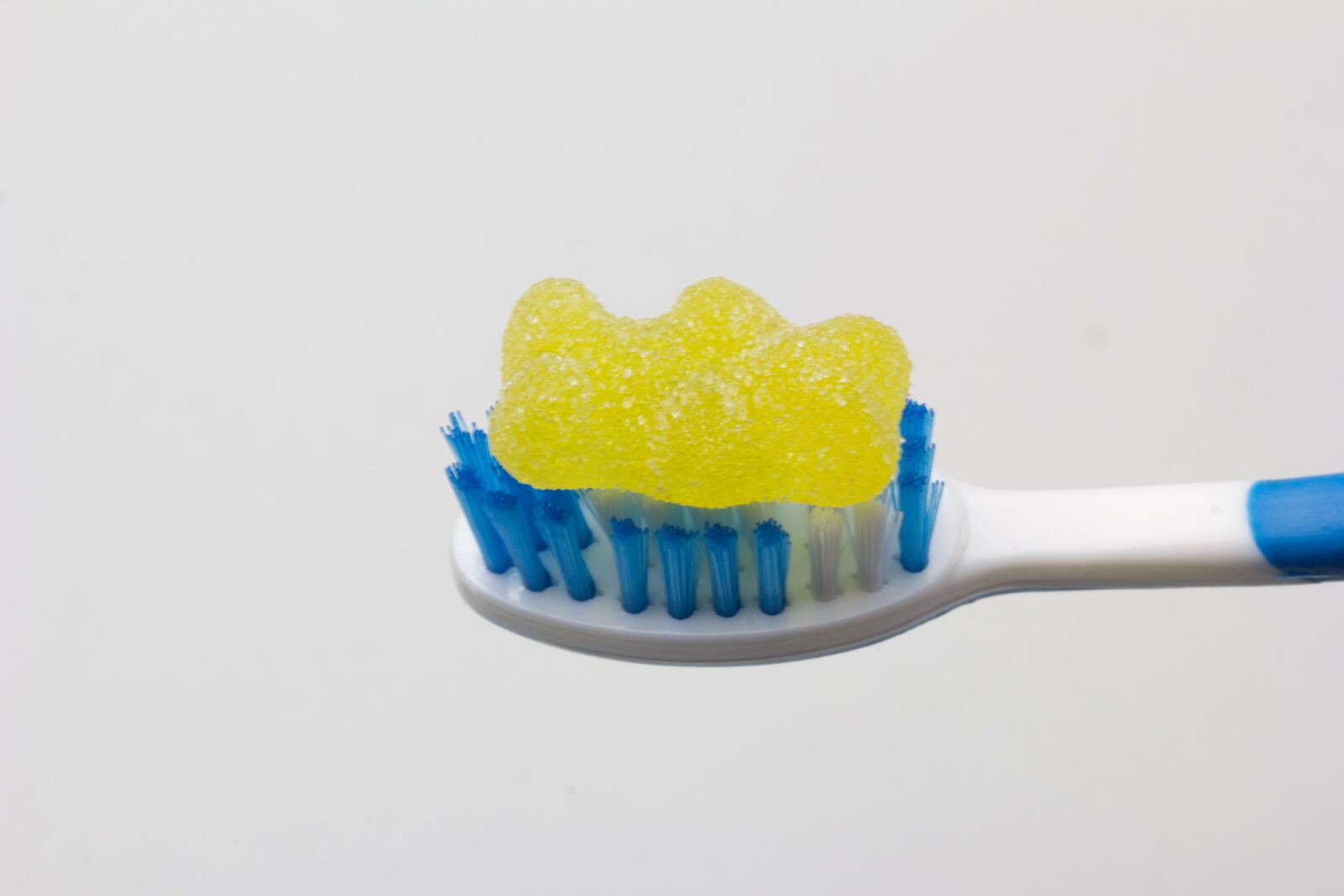 Canon EOS 60D + Canon EF 100mm F2.8 Macro USM sample photo. Jelly bean, toothbrush, decay photography