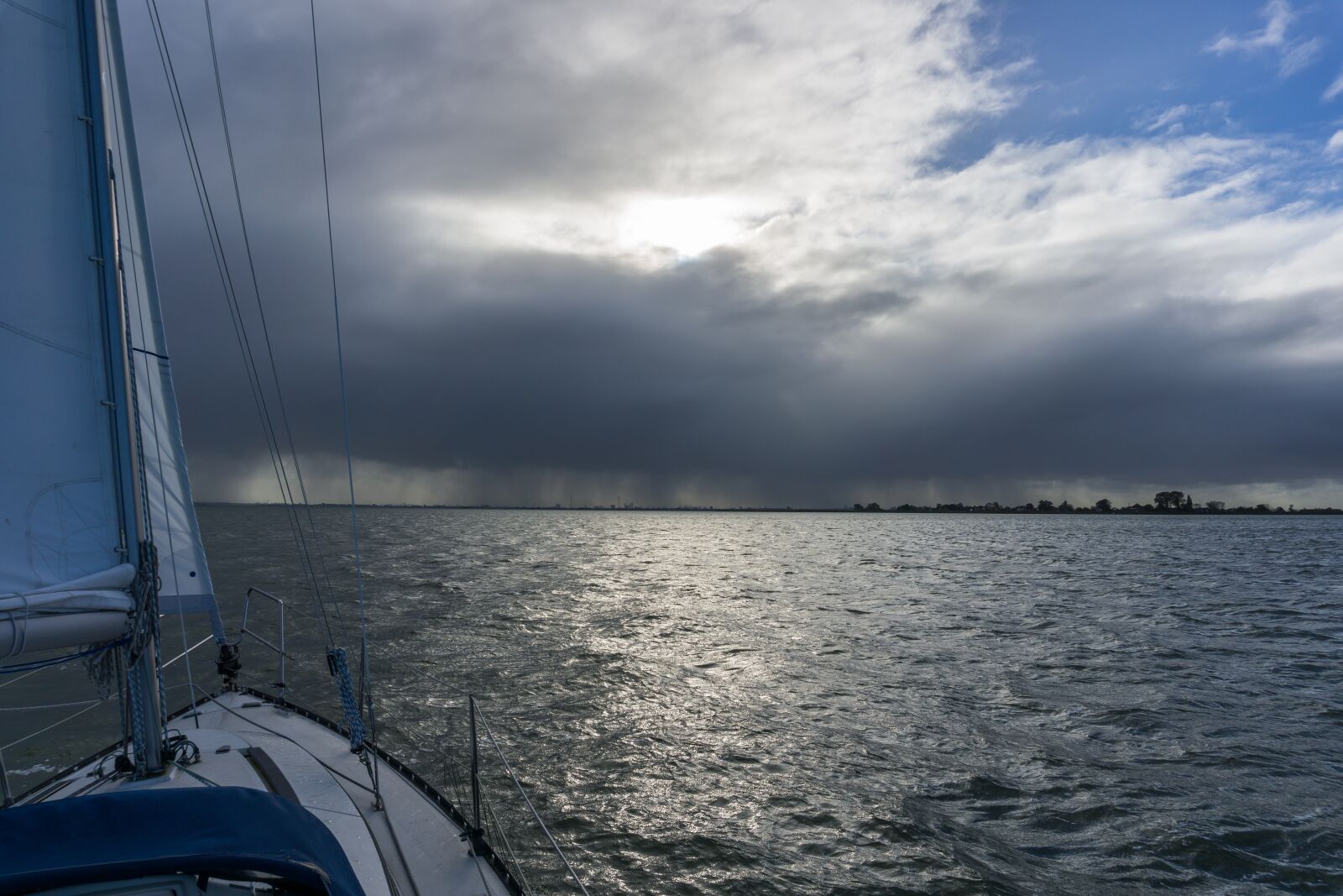 Sony a6000 sample photo. Sailing boat, clouds, air photography
