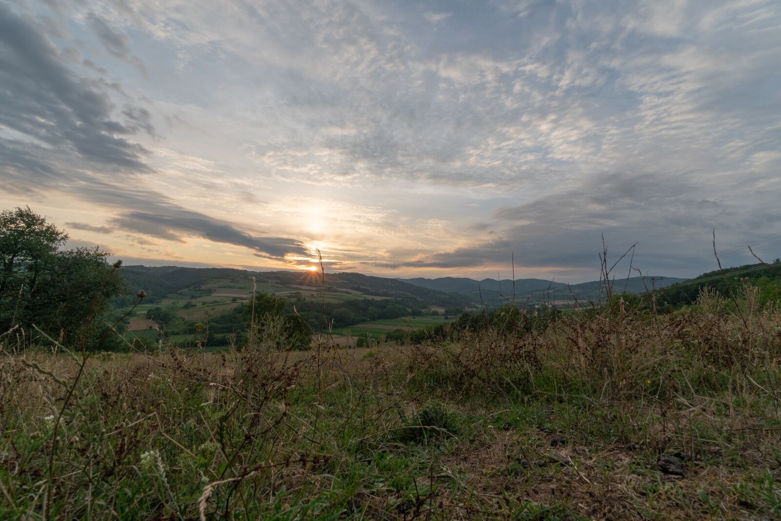Sony a6300 + Sony E 10-18mm F4 OSS sample photo. Sunset, clouds, meadow photography