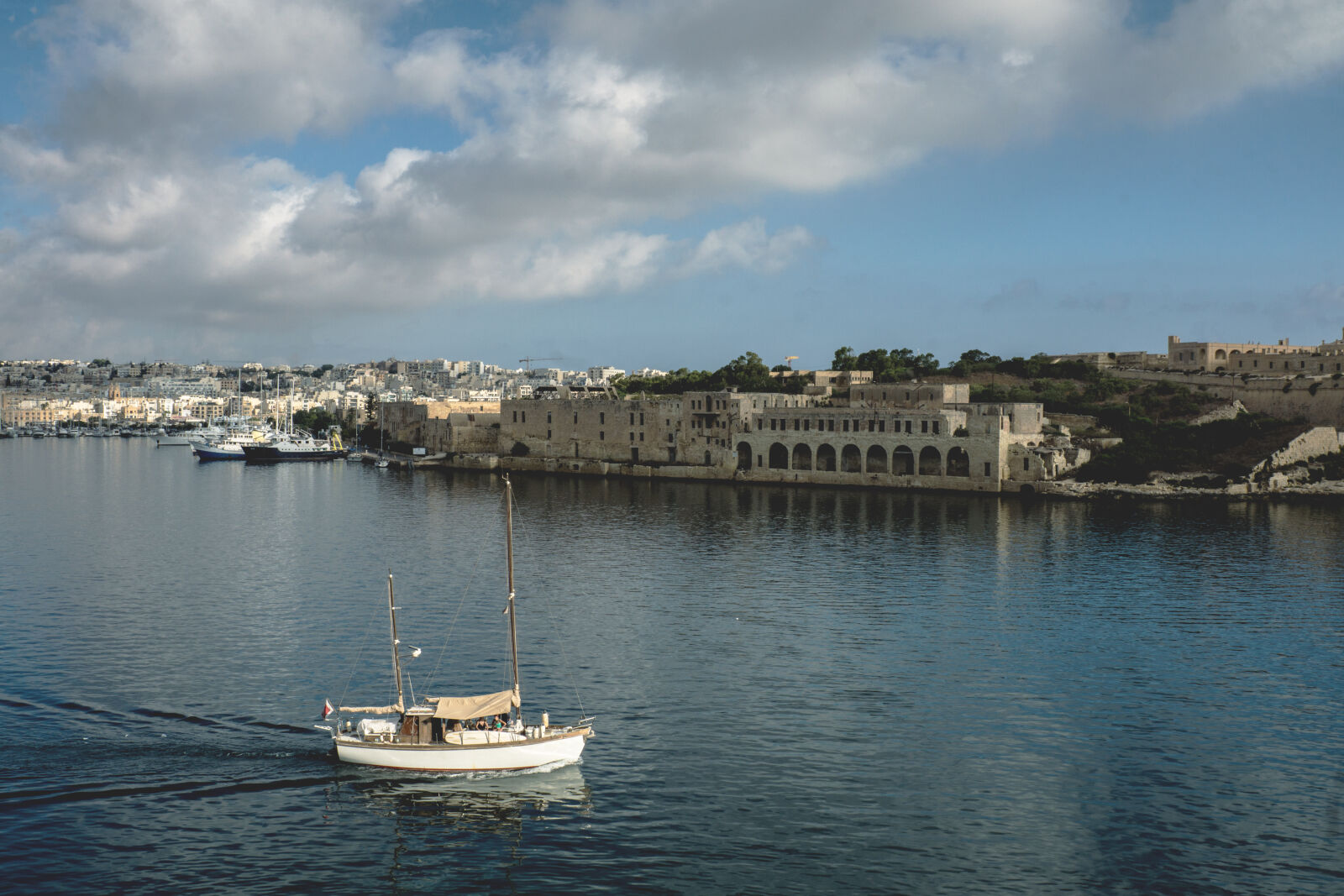 24-70mm F2.8-2.8 SSM sample photo. Boat, buildings, clouds, harbor photography