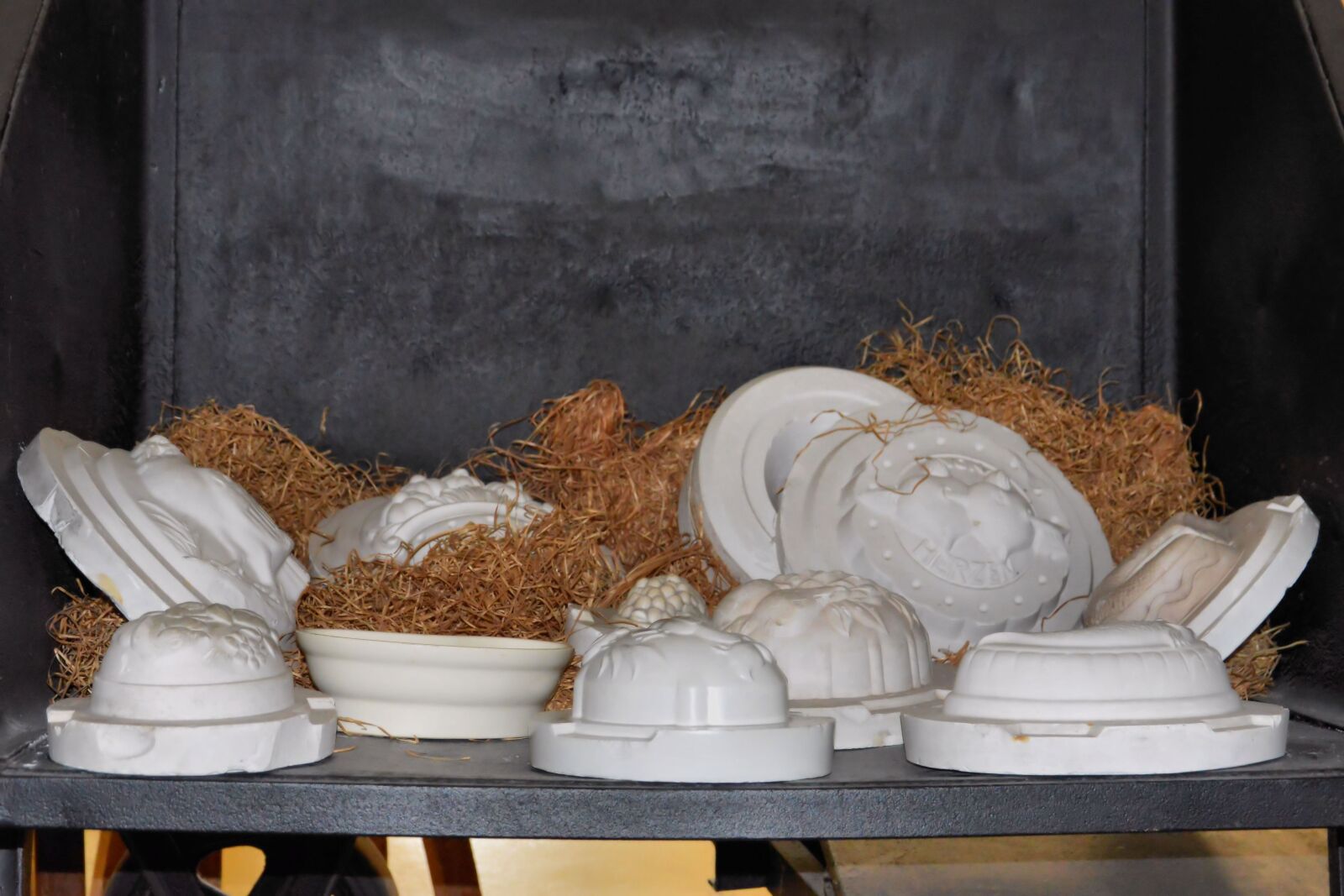 Nikon D3200 sample photo. Plaster moulds, wood wool photography