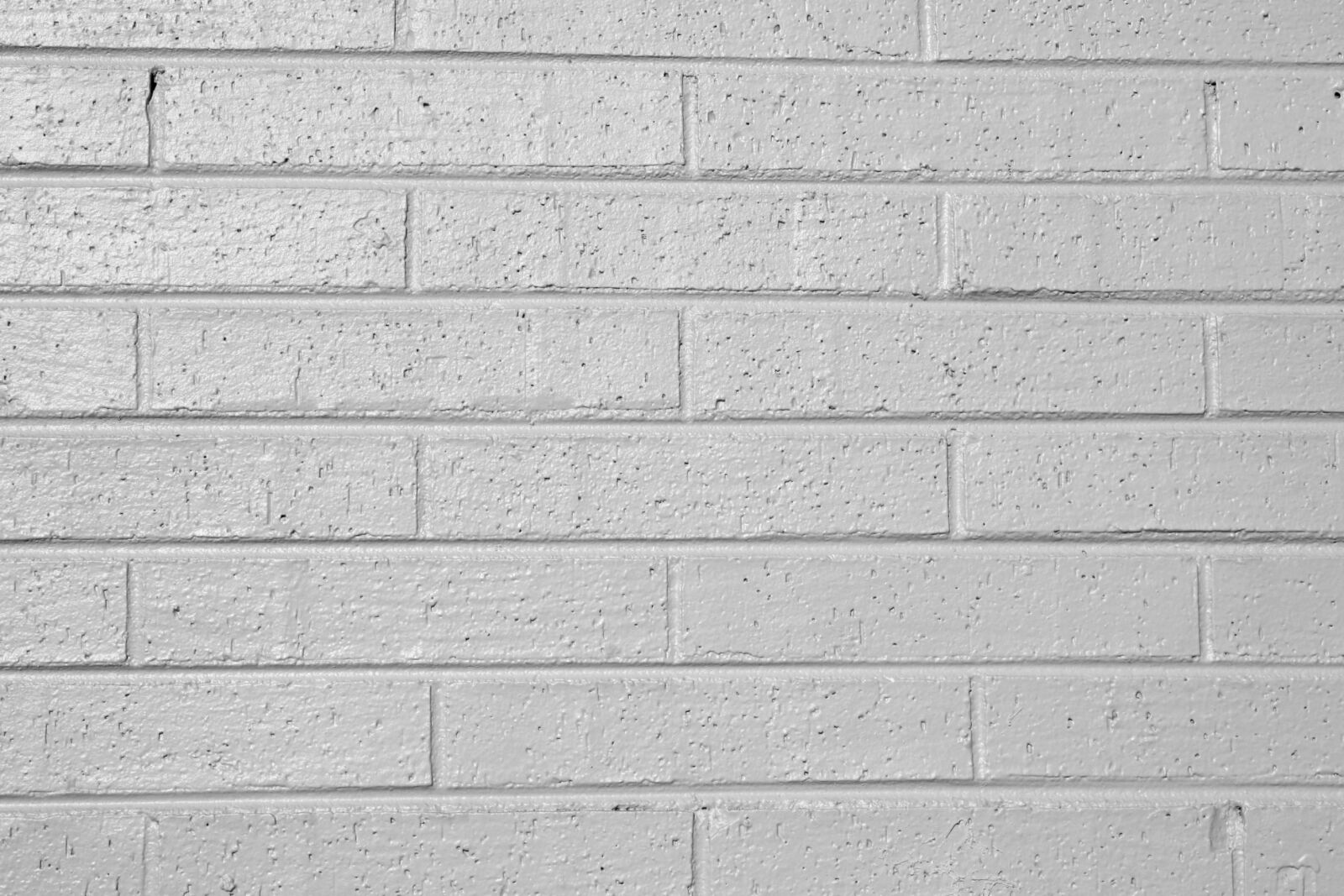 Canon EOS 1000D (EOS Digital Rebel XS / EOS Kiss F) + f/3.5-5.6 IS sample photo. Gray, painted brick wall photography