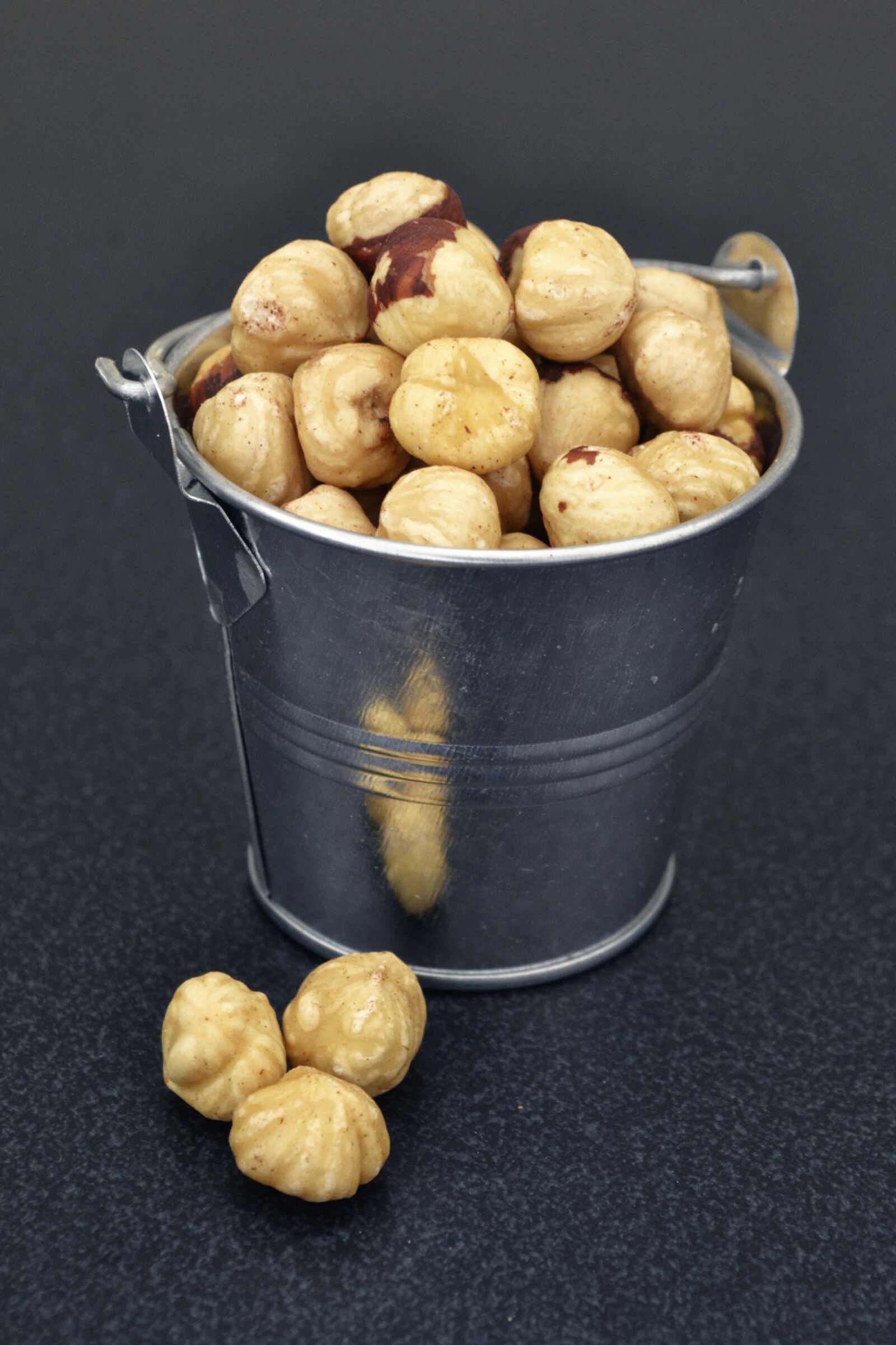 Nikon D3100 sample photo. Hazelnuts, metallic bucket food photography