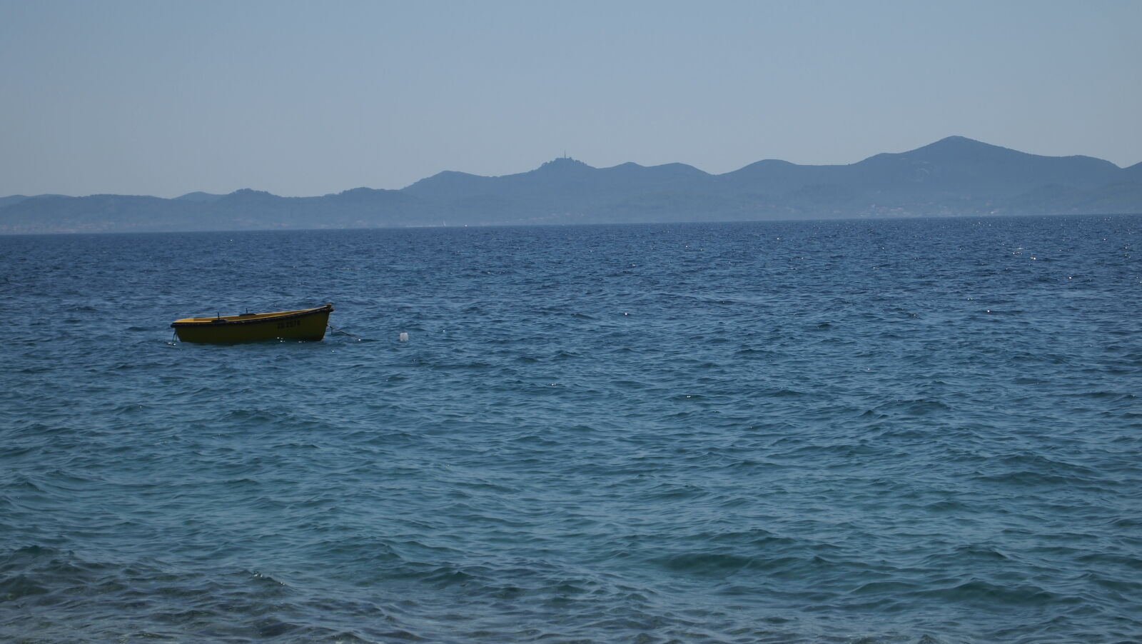 Olympus PEN E-PL1 sample photo. Blue, boat, coast, mountains photography